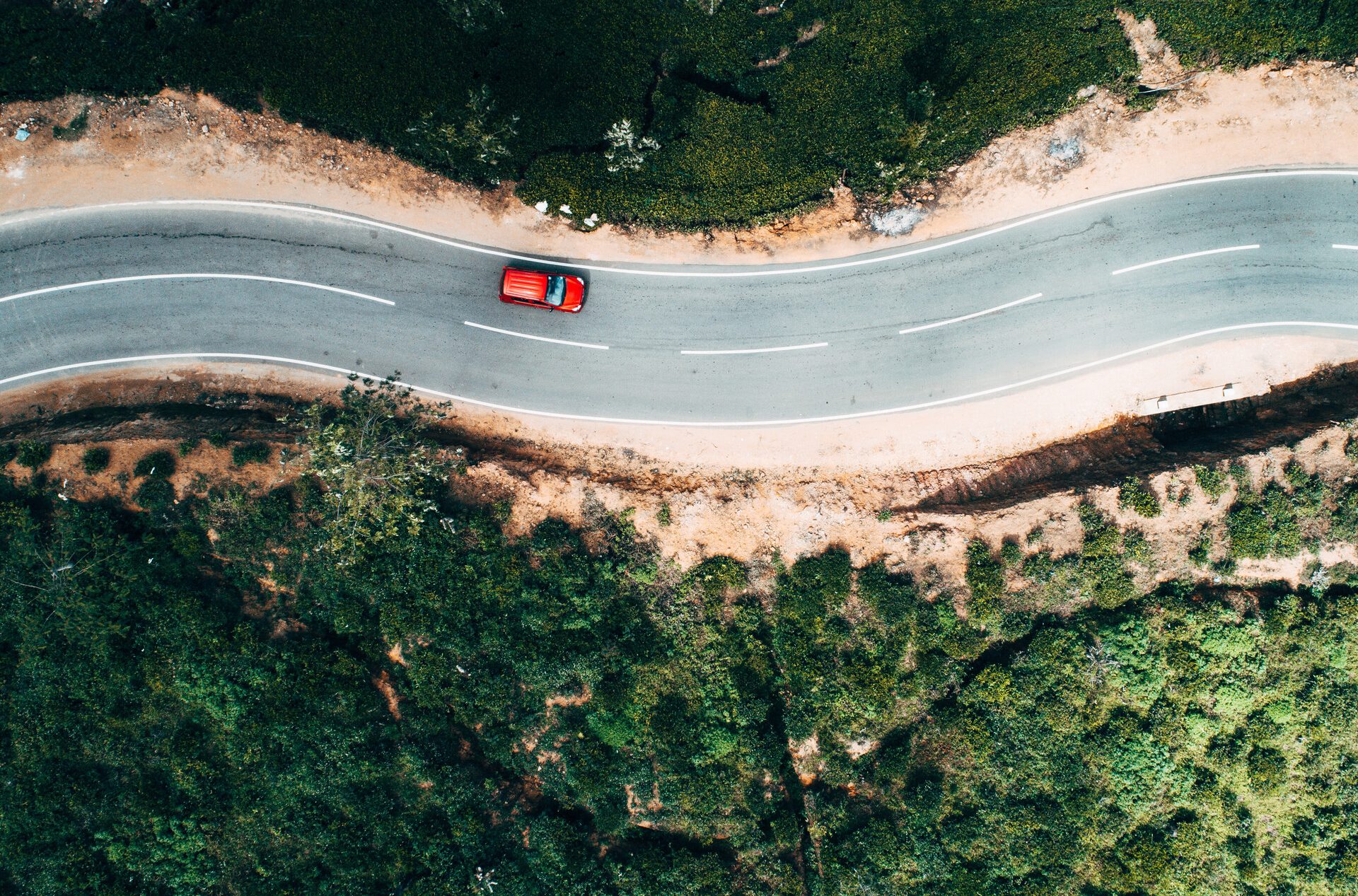 Aerial view of the car on a picturesque road.