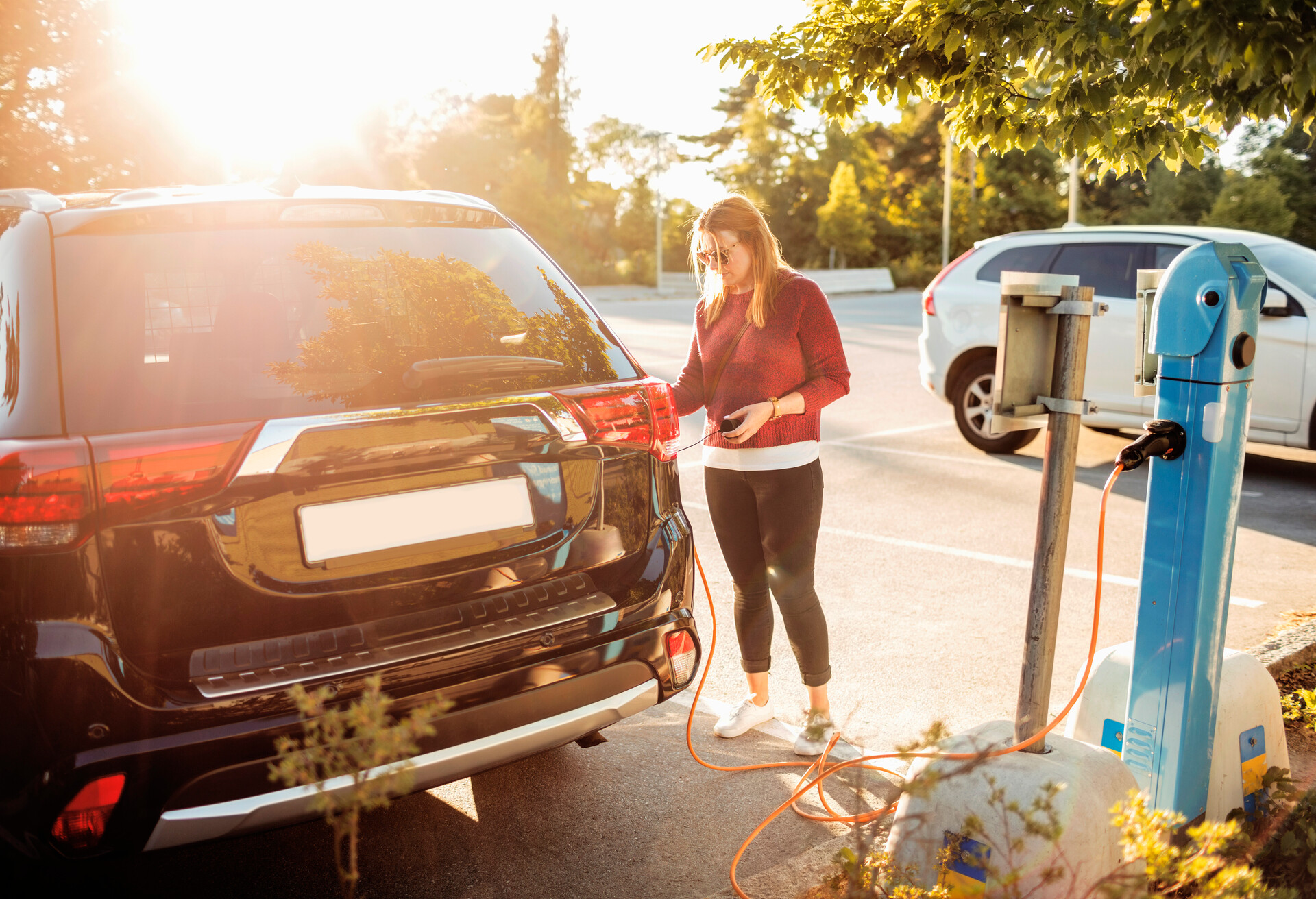 A girl charging an electric car