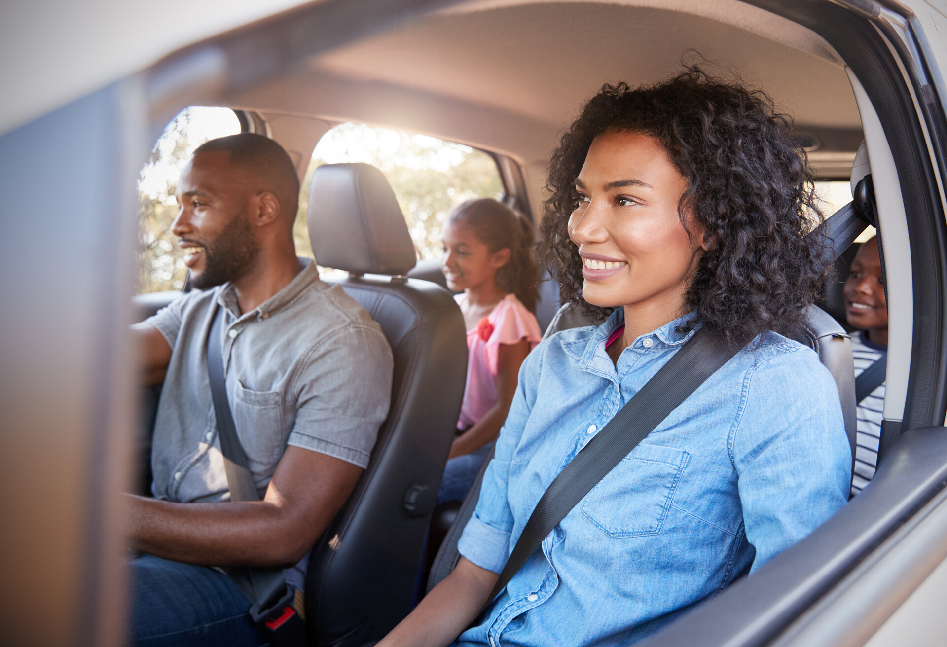 A family in car, enjoying the road trip.