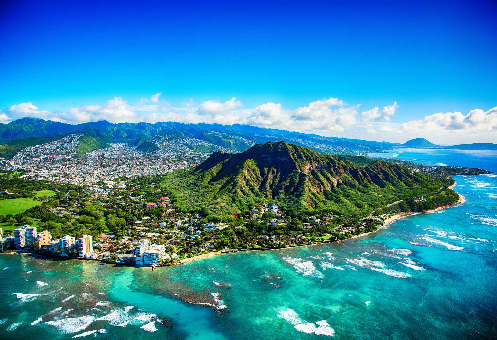 The dormant volcano known as Diamond Head located adjacent to downtown Honlulu, Hawaii, as shot from an altitude of about 1500 feet over the Pacific Ocean.