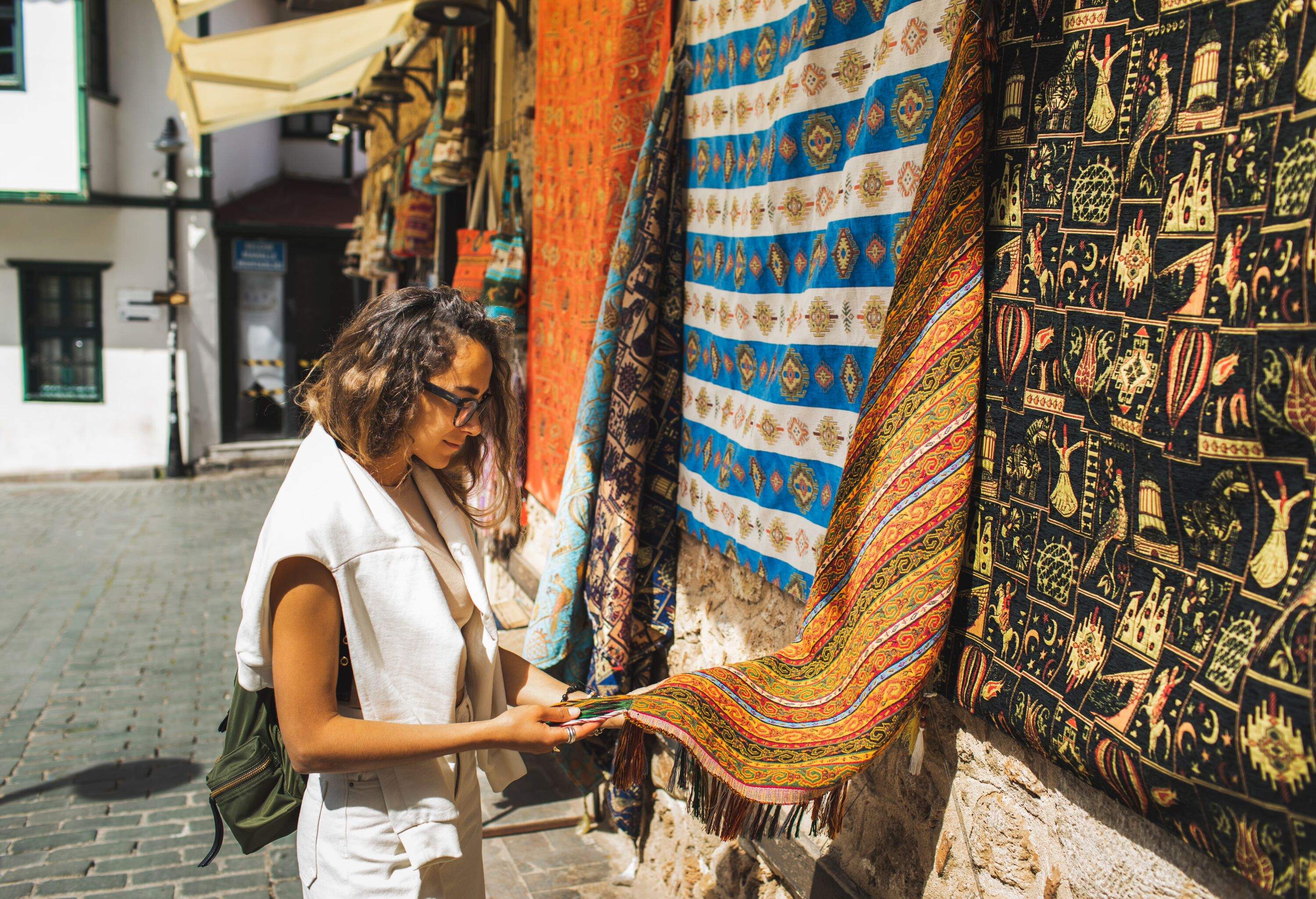 Muslim or arab culture. People shopping in travel. Handmade souvenir in Marrakech medina local market. Beautiful vibrant handicraft carpet in middle eastern style.