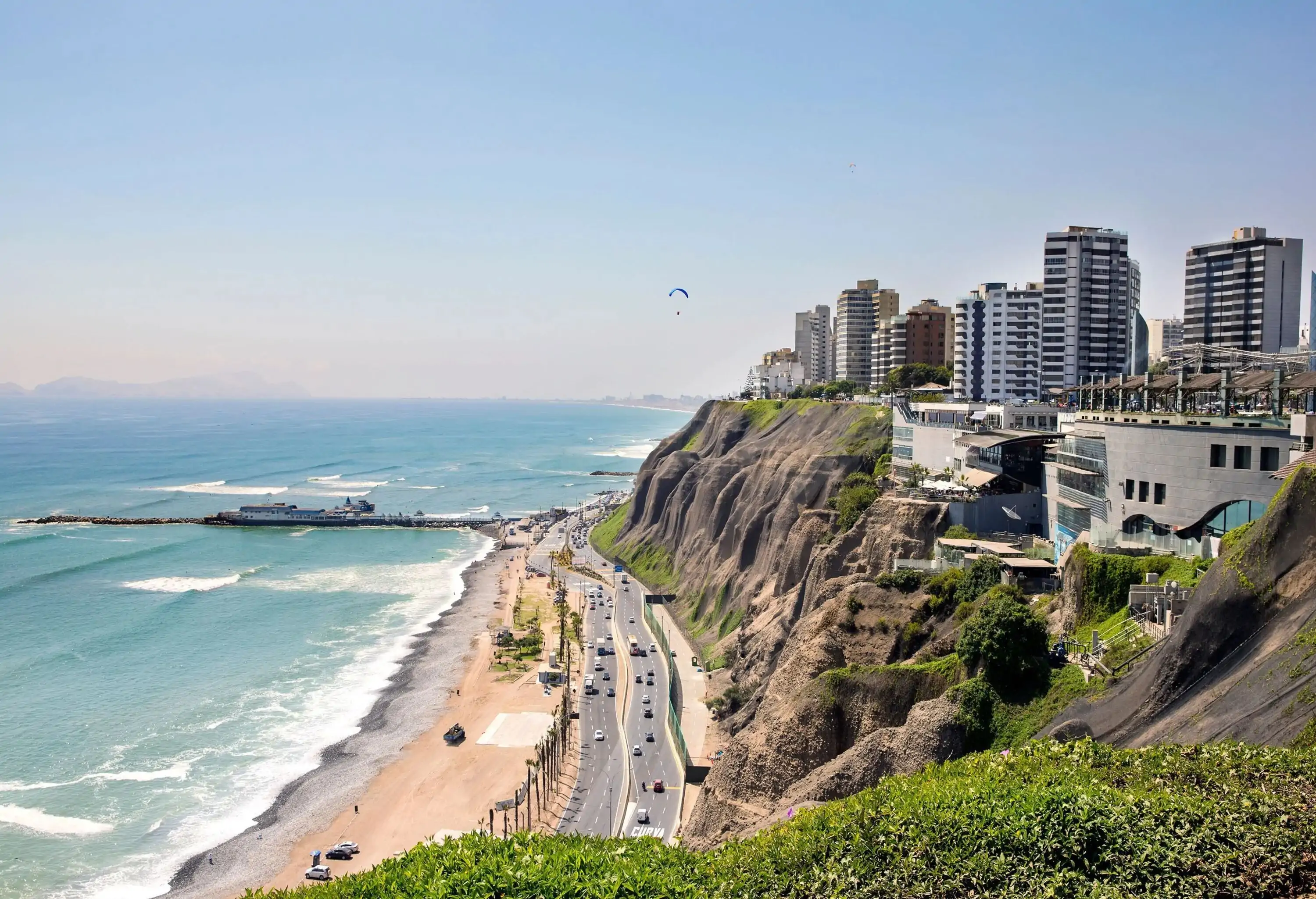 A coastal metropolitan region with motorways running along the coastline and large skyscrapers perched on cliffs.