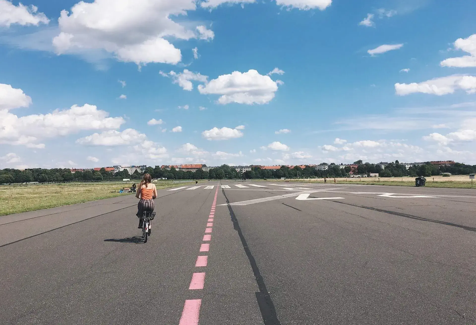 Woman cycling on Tempelhofer Feld, Berlin, Germany