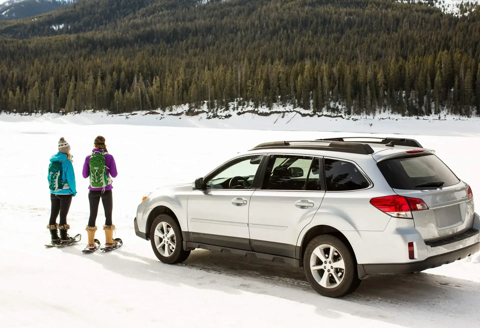 Two people standing next to a car rental