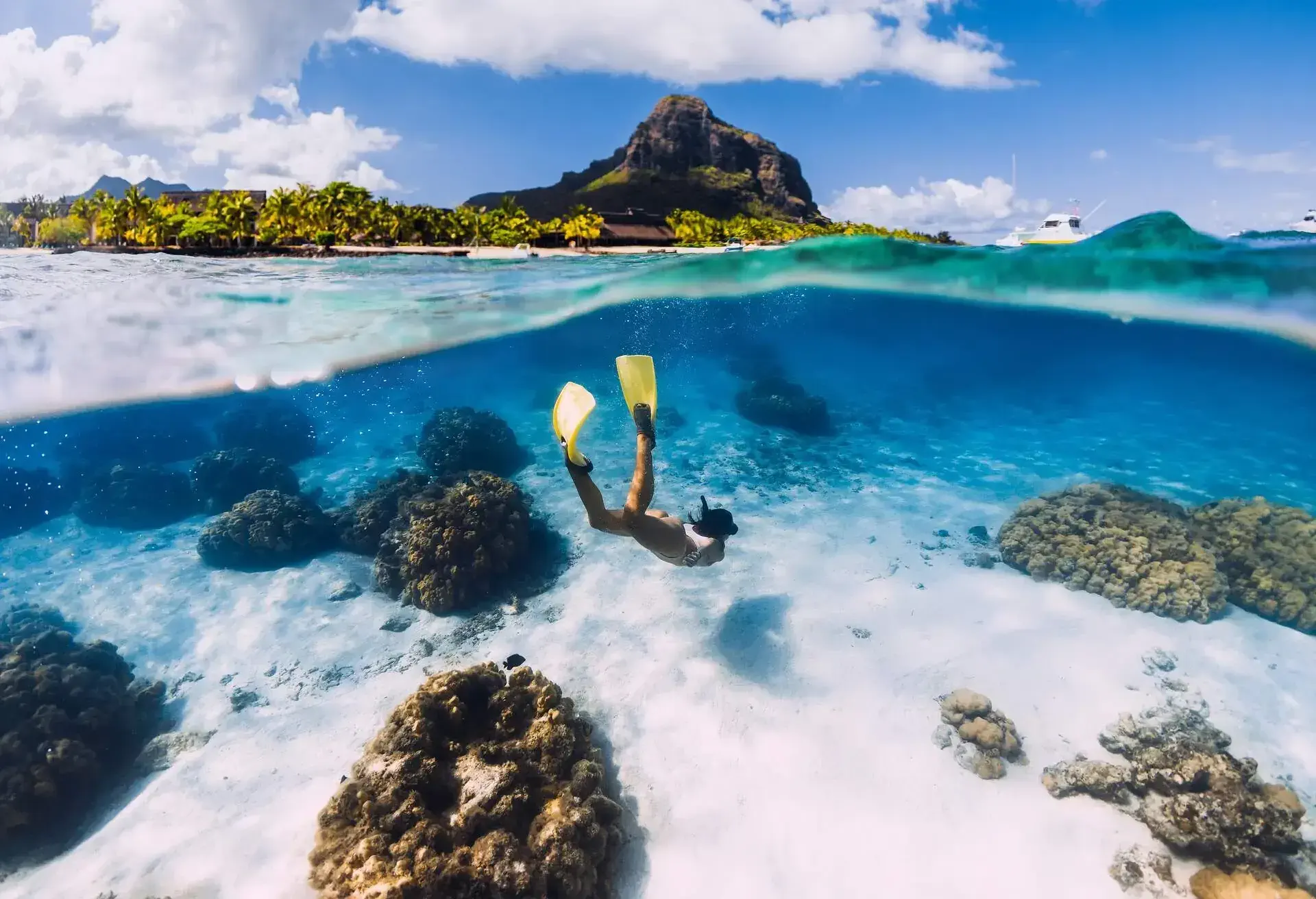Person scuba diving in clear blue water in Mauritius