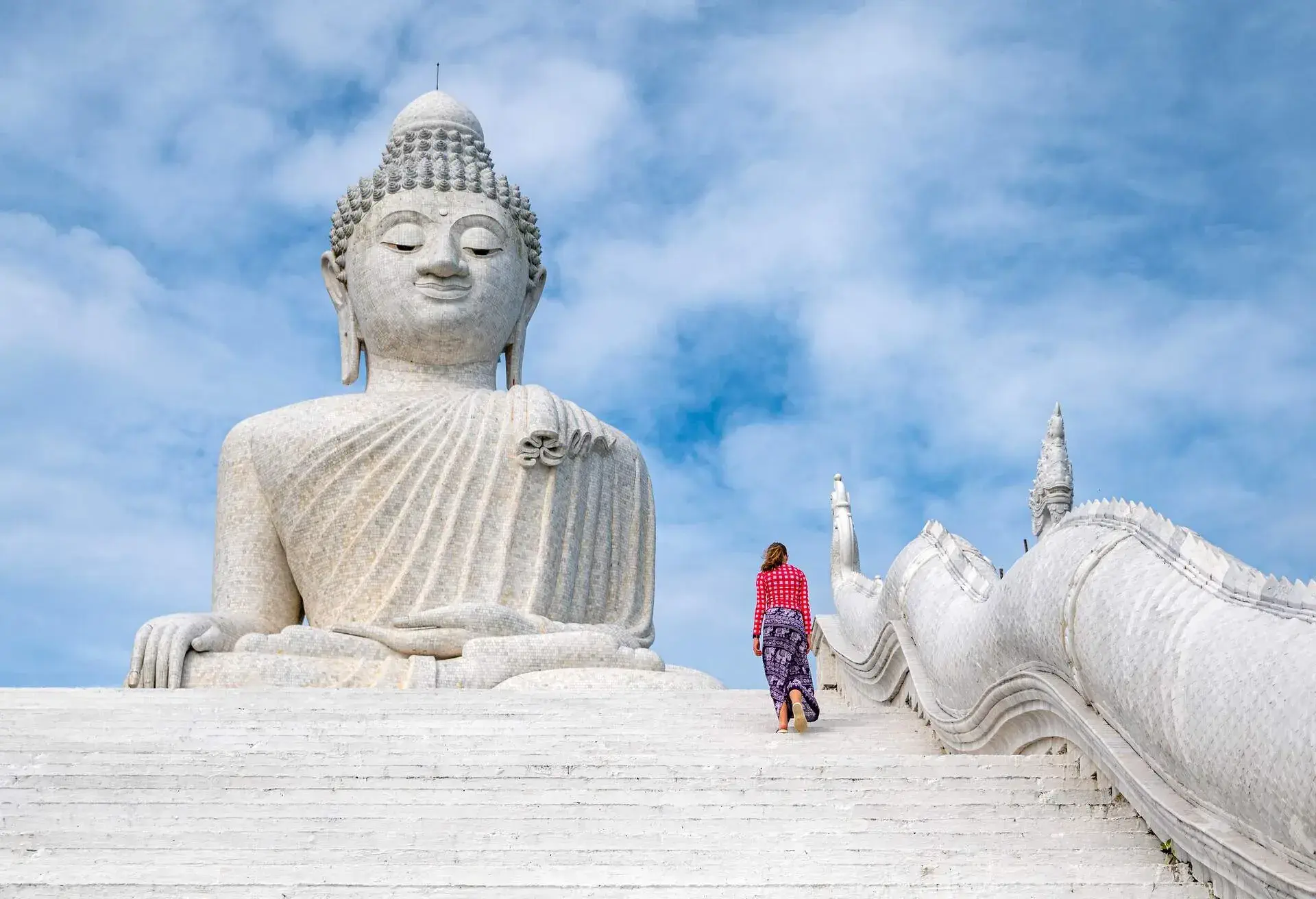 a girl climbing the stairs to White marble statue of Big Buddha in Phuket,Thailand