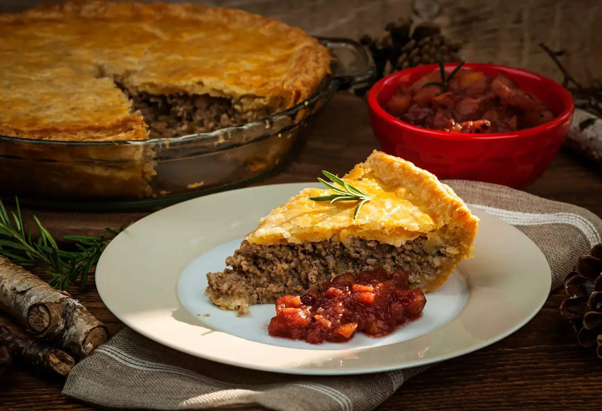 Slice of French Canadian Tourtiere on a white/grey plate