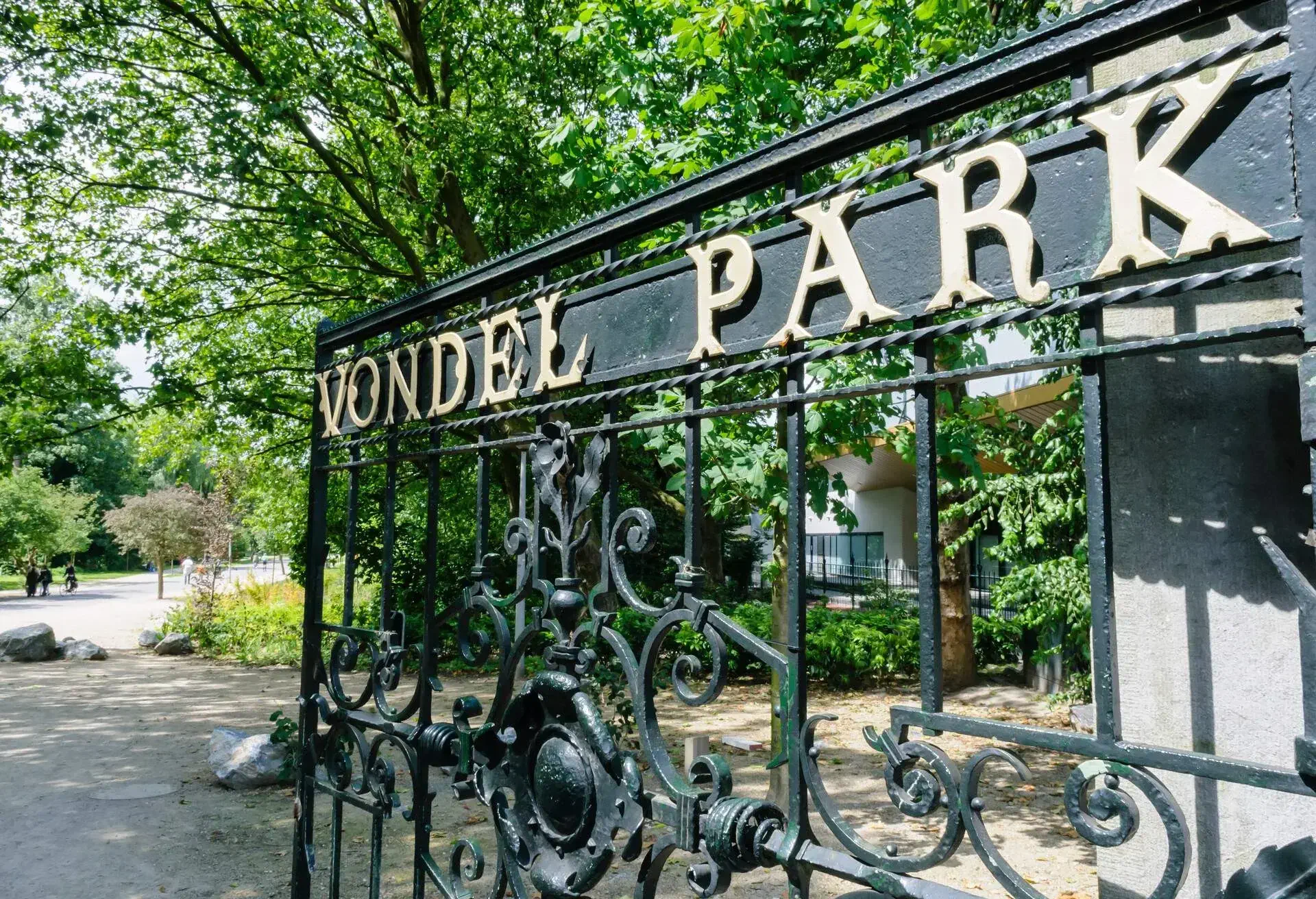 A wrought iron gate with letters that spell VONDEL PARK on it.