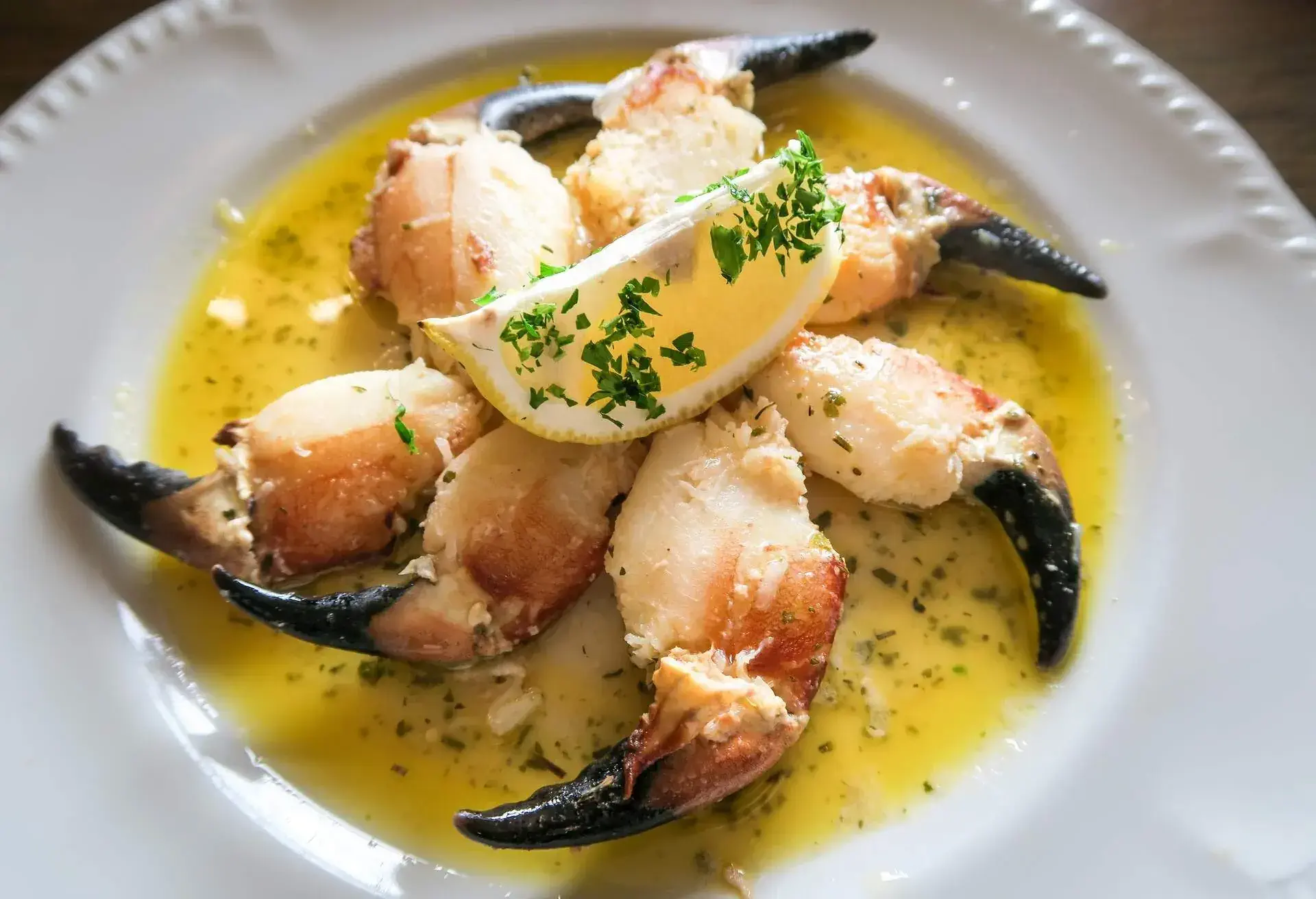 Pinkish crab claw fingers served in yellow buttery sauce in Irish seaside village.
