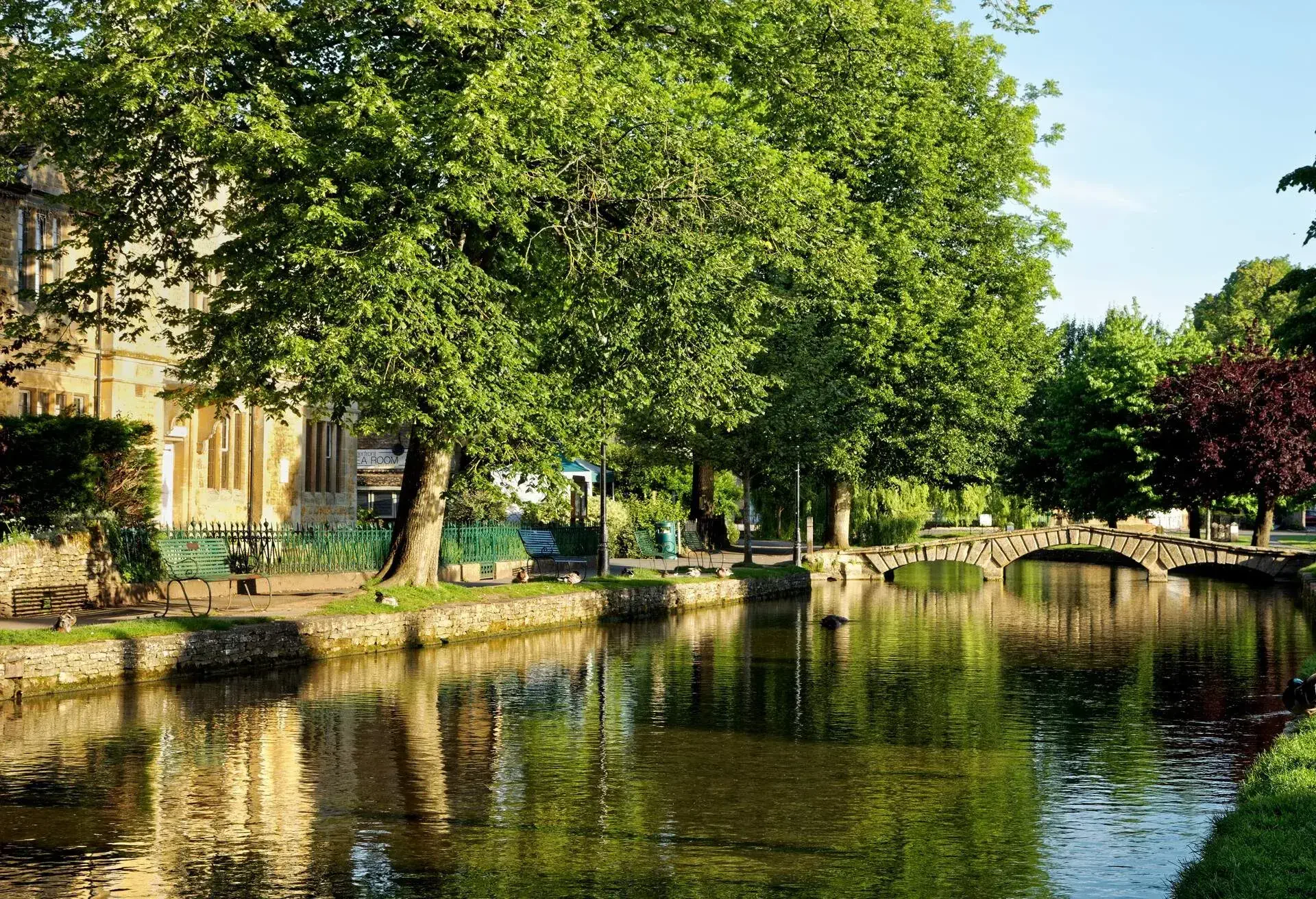 A bridge above the water and some nice buildings and trees