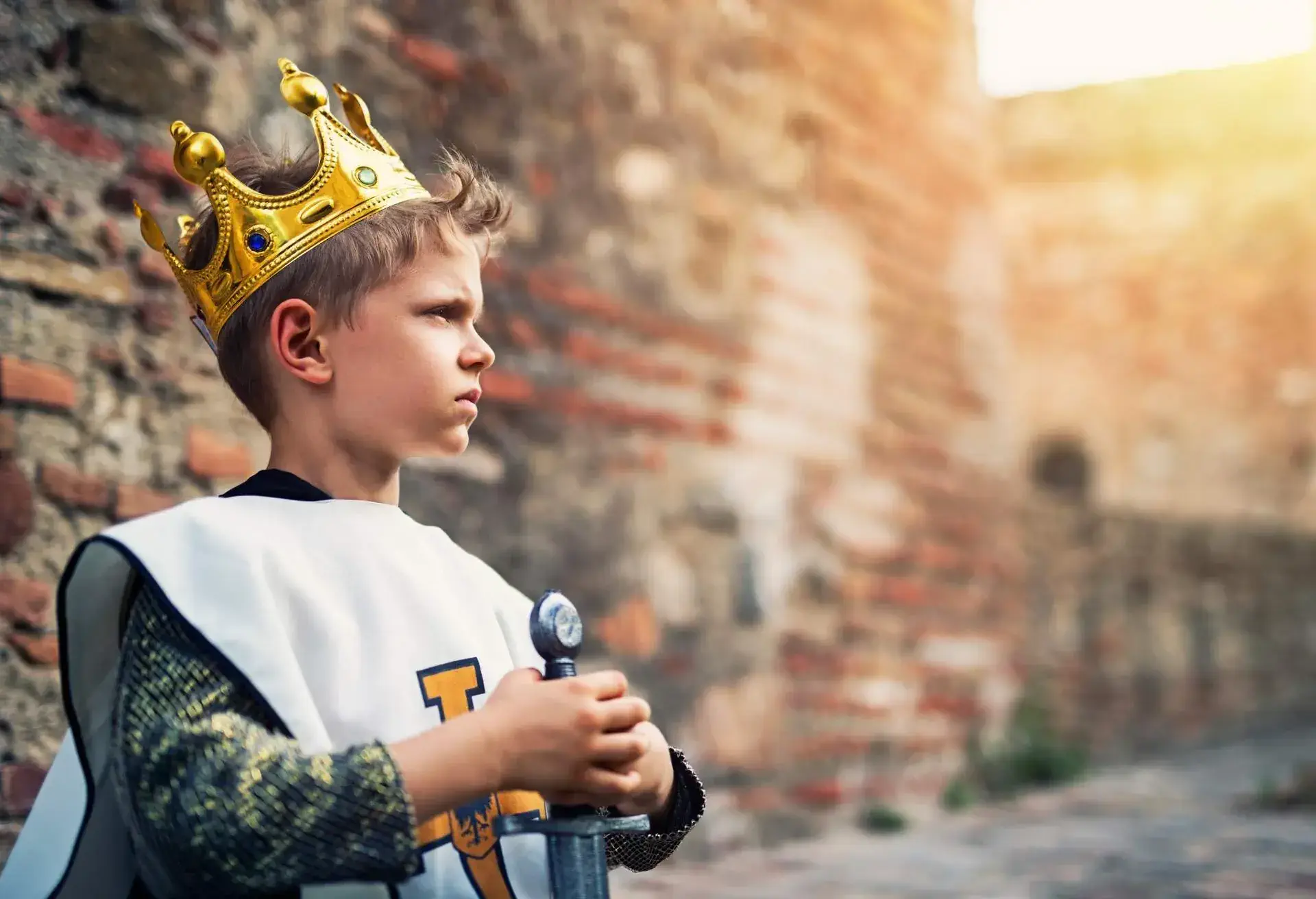A boy dressed as a knight holding a sword