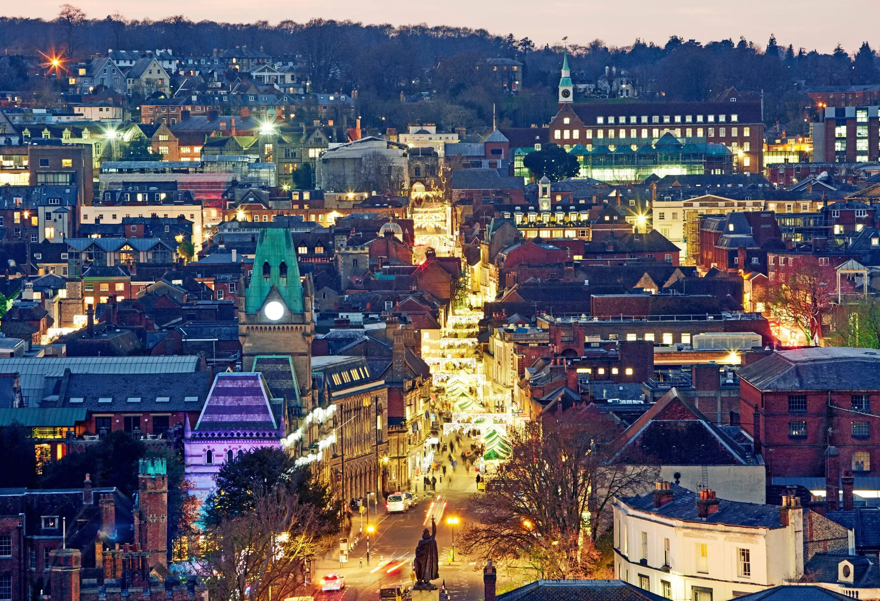 A Christmas market stretching through the main street crowded with people.