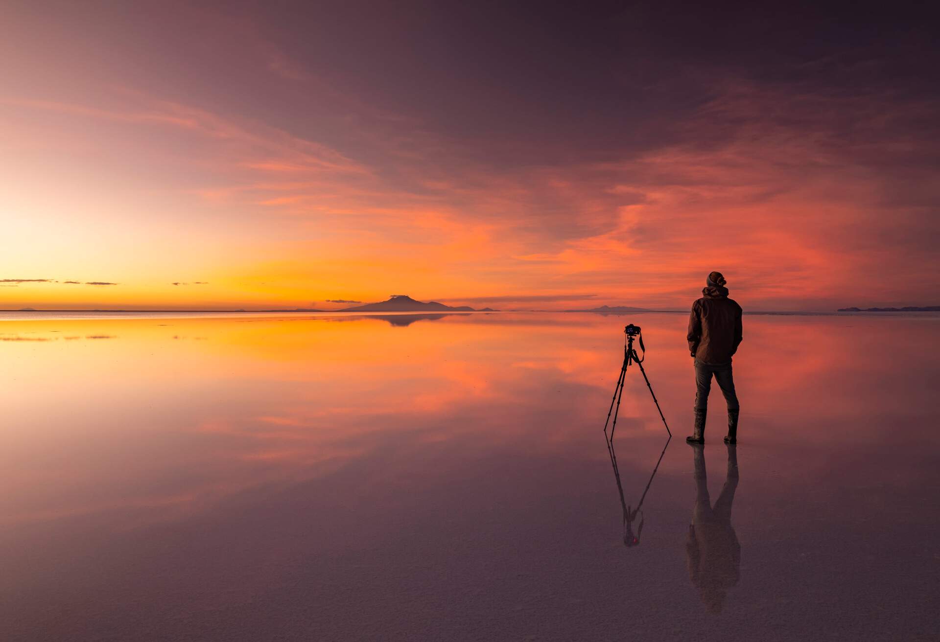 Uyuni in the rainy season is covered with a thin layer of water that reflects the sky with clouds