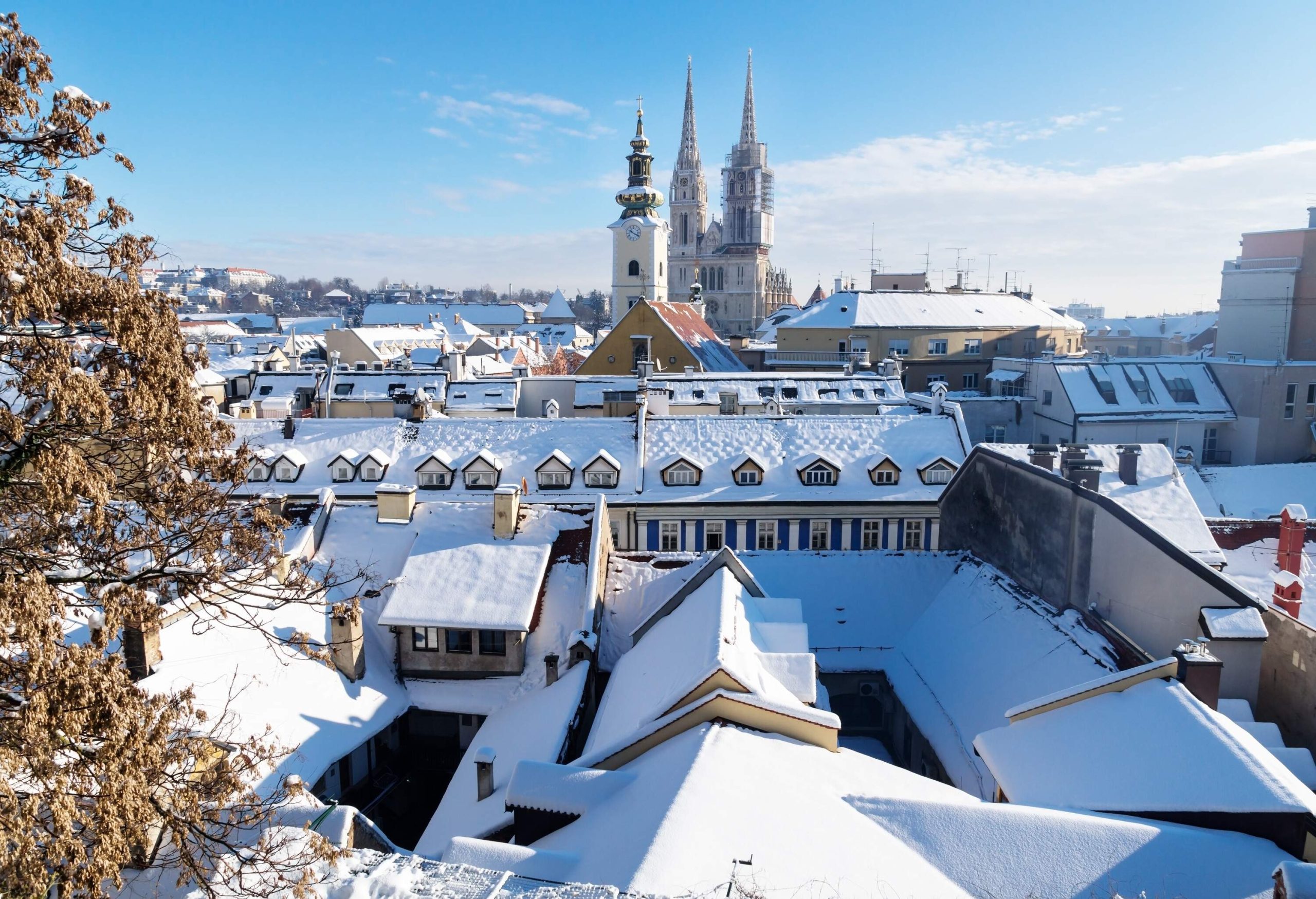 Stunning cityscape, with towers and church steeples peeking out from behind snow-covered buildings.