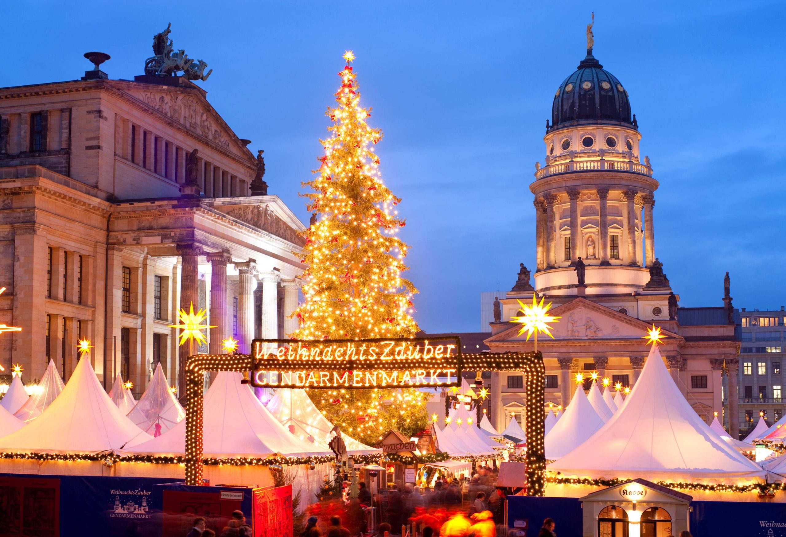 Street view of Christmas market on Gendarmenmarkt, Berlin, Germany at dusk