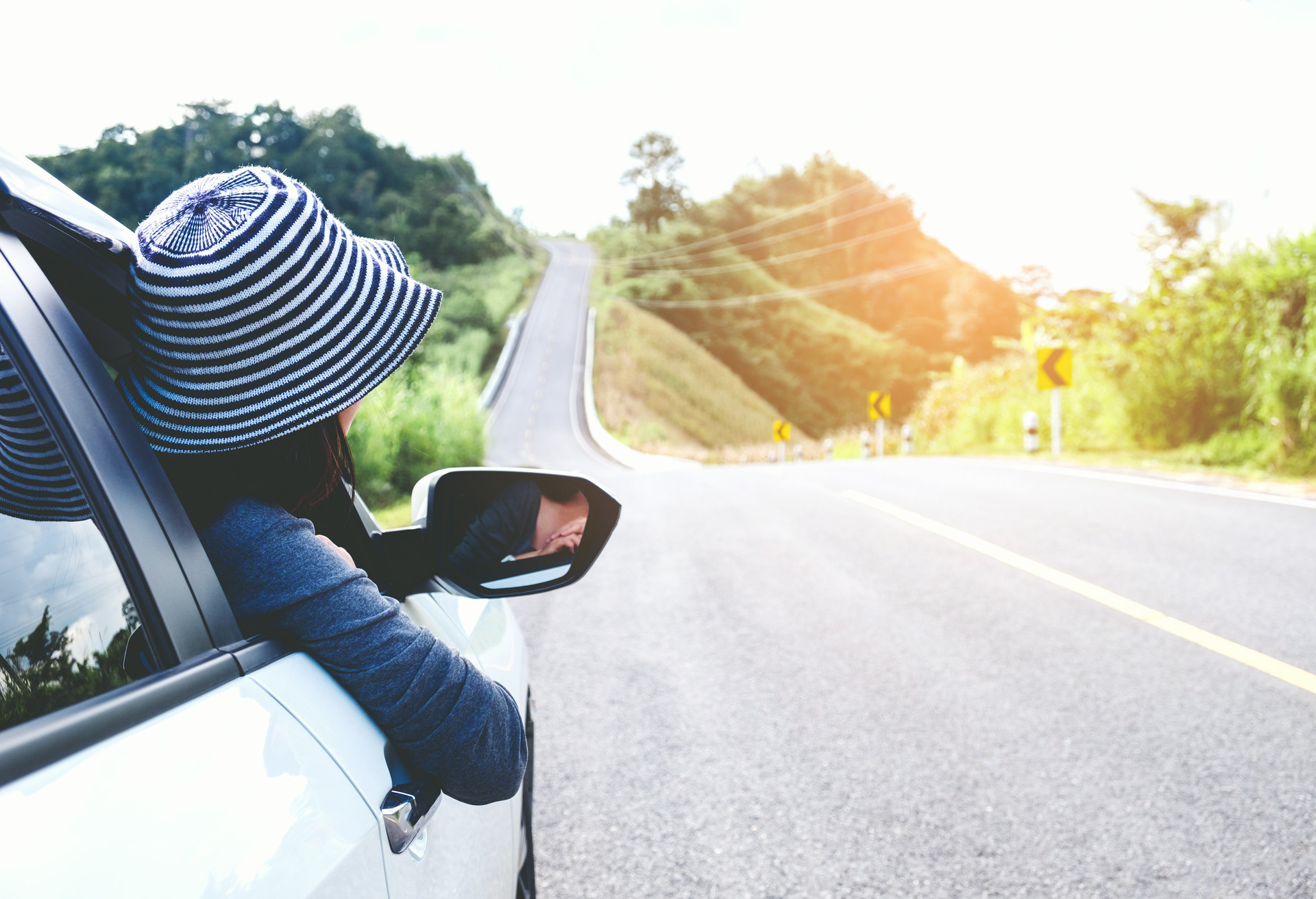 Asian woman traveler with car on Beautiful road