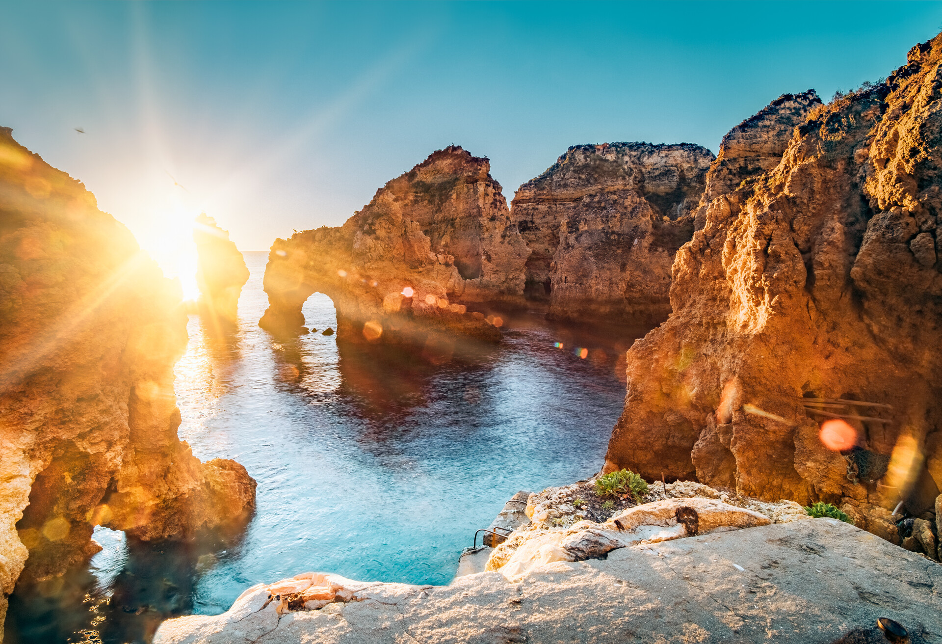 Golden sunrise on the red cliffs of Ponta Da Piedade, Lagos, Algarve, Portugal.