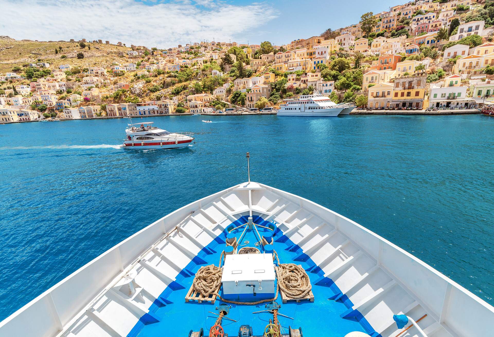 The bow of the cruise ship overlooking the tourist attraction - the city and the island of Symi, Greece