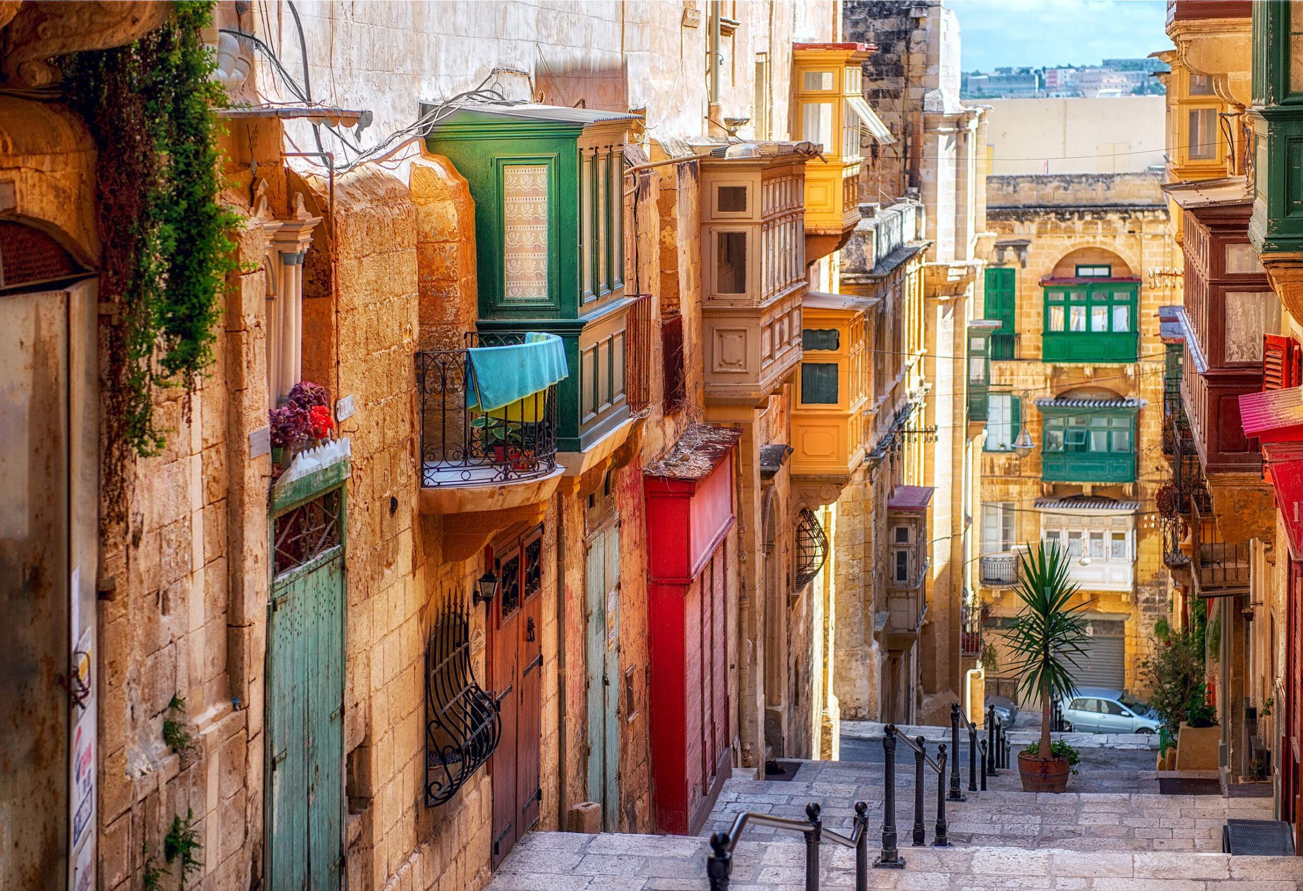 A picturesque narrow street with steps is flanked by stunning and timeless buildings, creating an enchanting atmosphere.