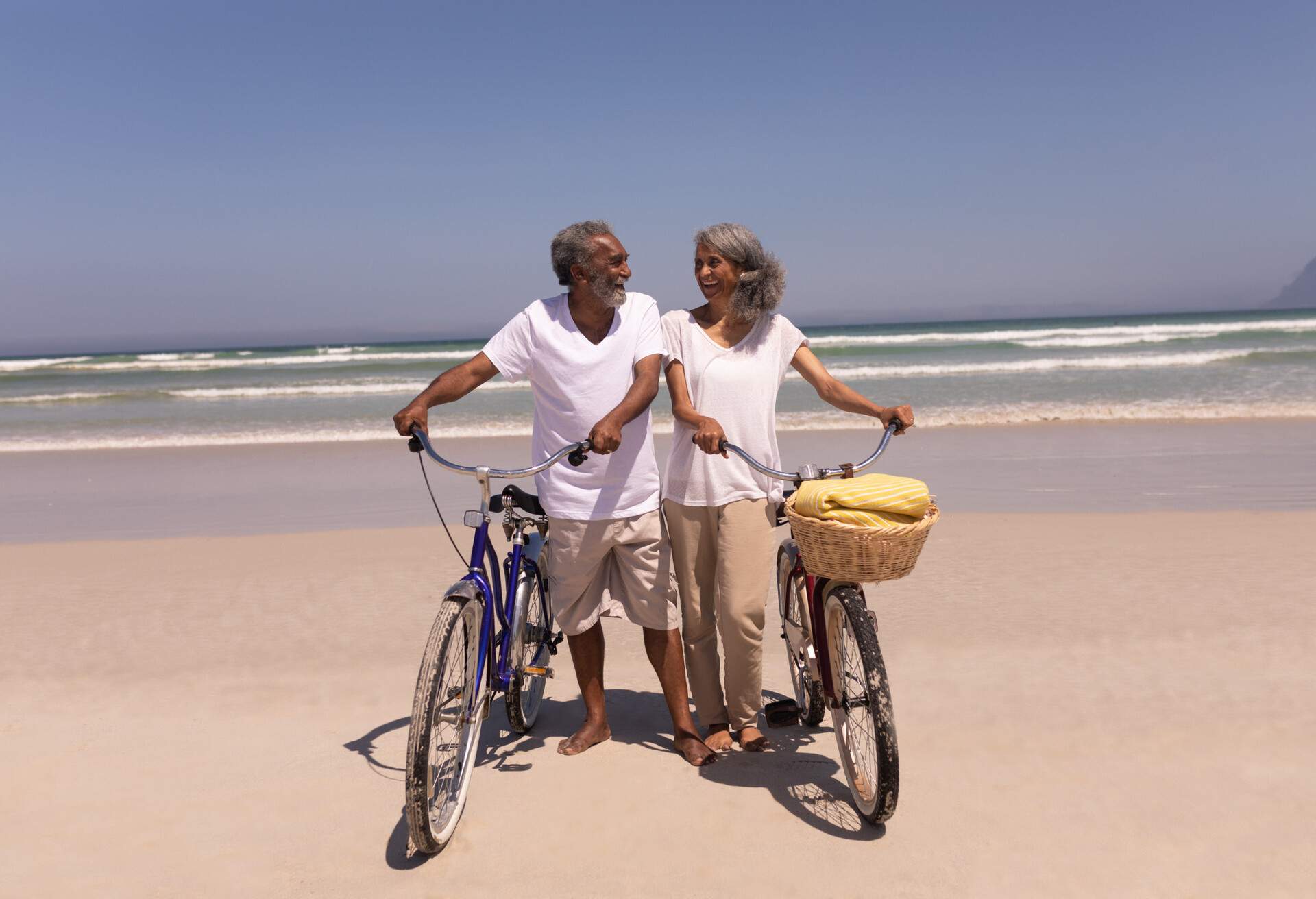 people_couple_vacation_beach_ocean_bicycles_bikes_senior-