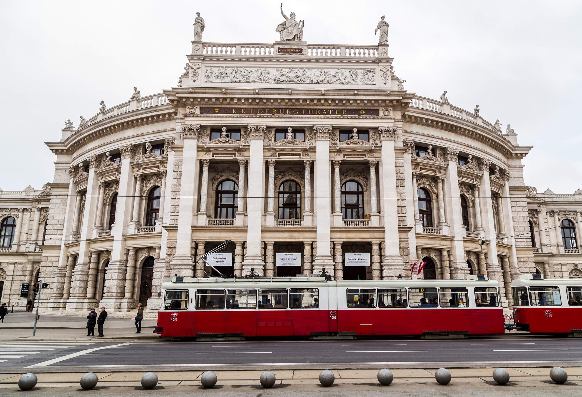 A tram stops in front of the historic Burgtheater in Vienna.
