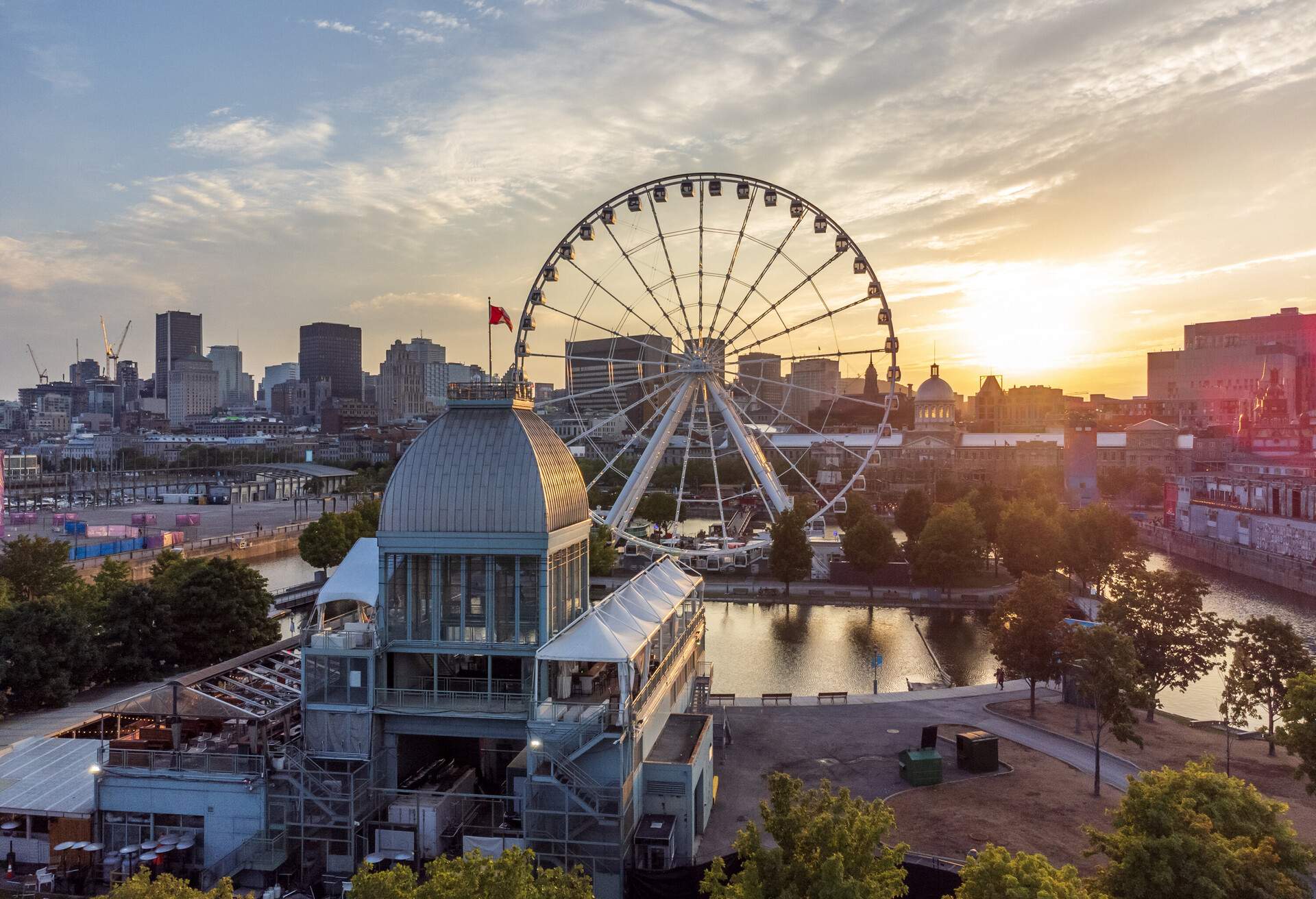 A giant Ferris wheel emerges in the centre of compact buildings.