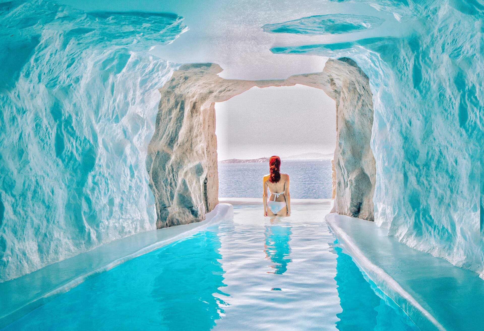 dest_greece_mykonos_theme_people_woman_on_a_cave_pool_gettyimages