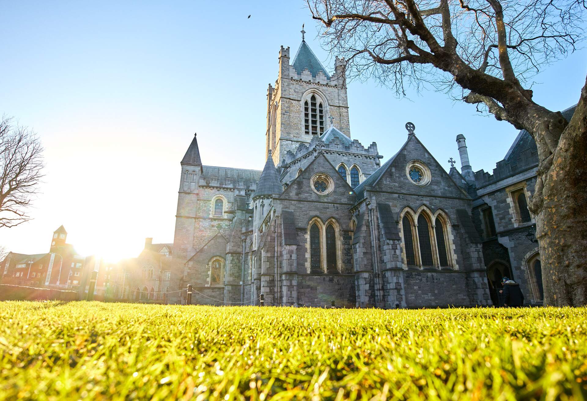 The sun shining peaking through the roofs behind The Christ Church Cathedral in Dublin on an early spring day 