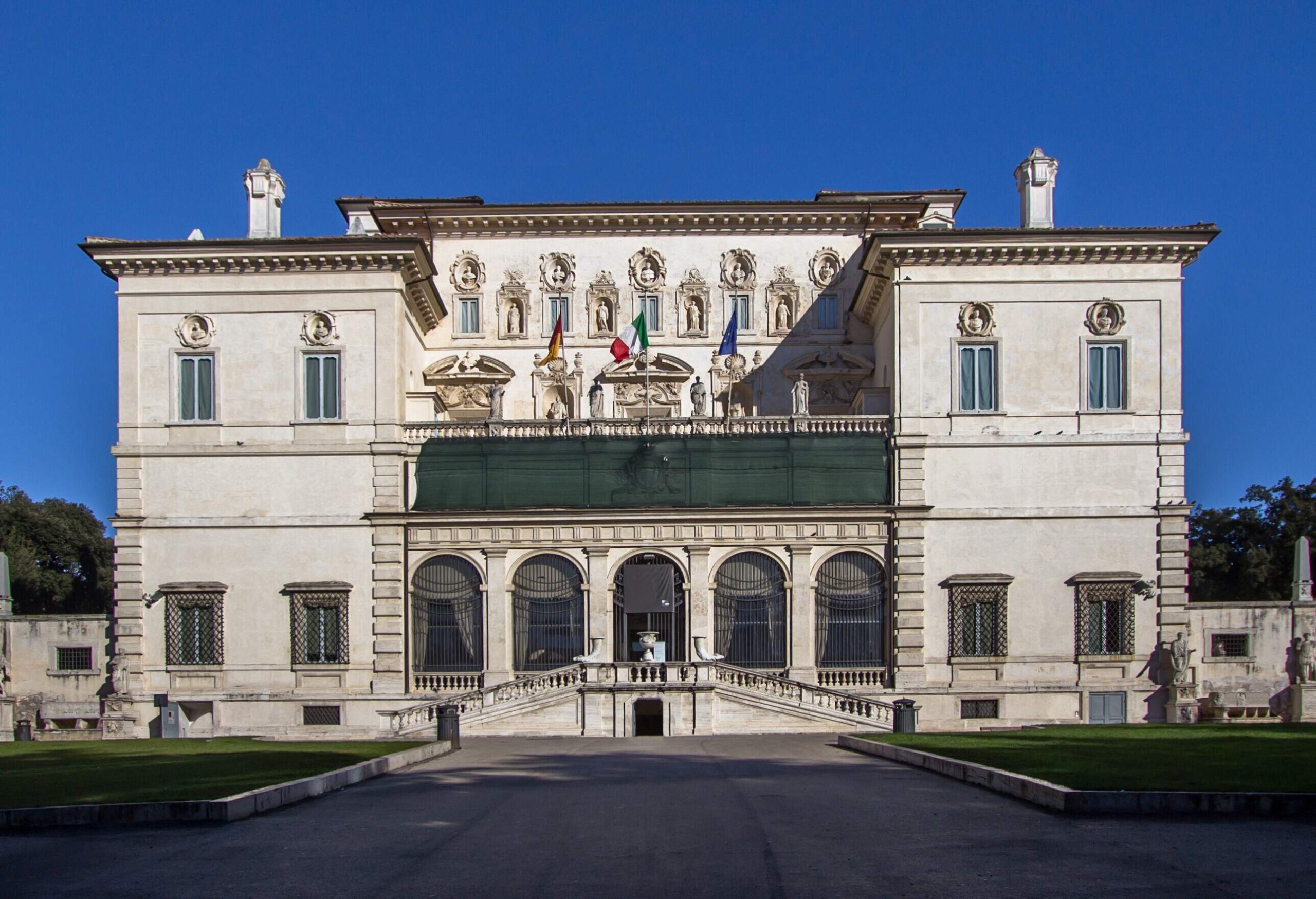 Galleria Borghese is an art gallery with a grand front staircase, arch windows, and intricately carved façade between two square buildings.