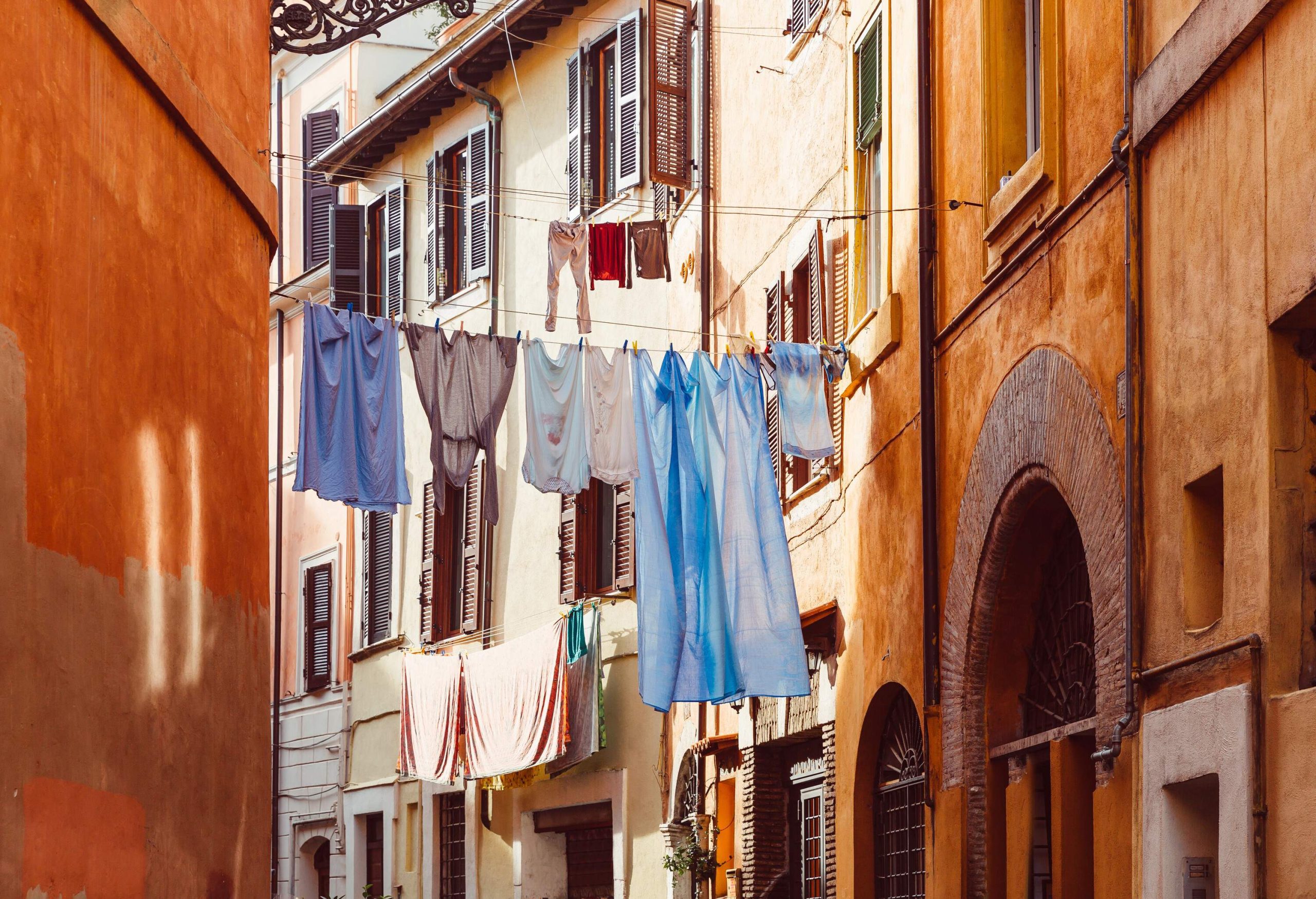 Household linens and clothes hanging out to dry across the street.
