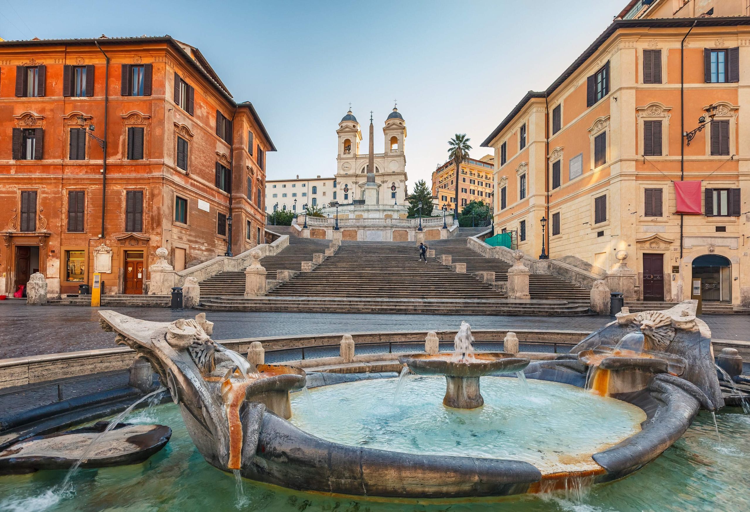 An ancient water fountain in front of the Spanish Steps and the Trinità dei Monti.
