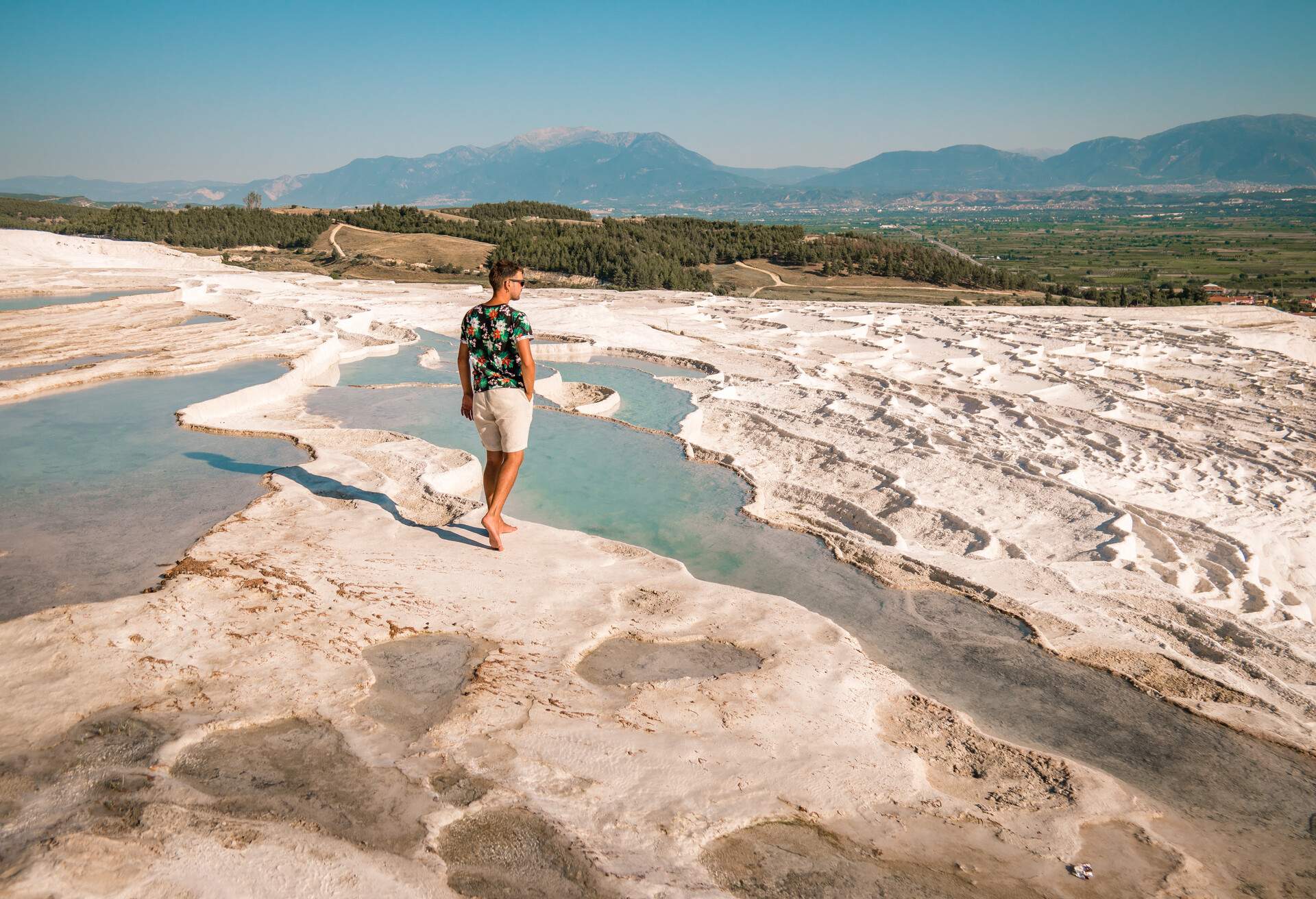 Natural travertine pools and terraces in Pamukkale. Cotton castle in southwestern Turkey, young man walking at the pool in natural bath ; Shutterstock ID 1167275008; Brand (KAYAK, Momondo, Any): any