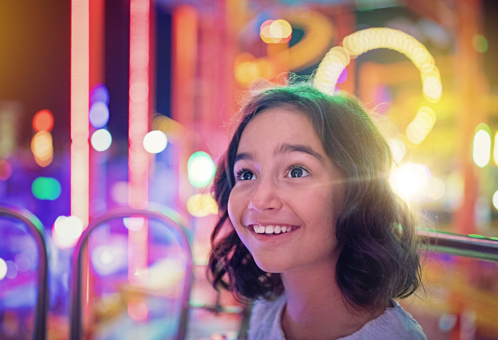 Happy girl is smiling on ferris wheel in an amusement park