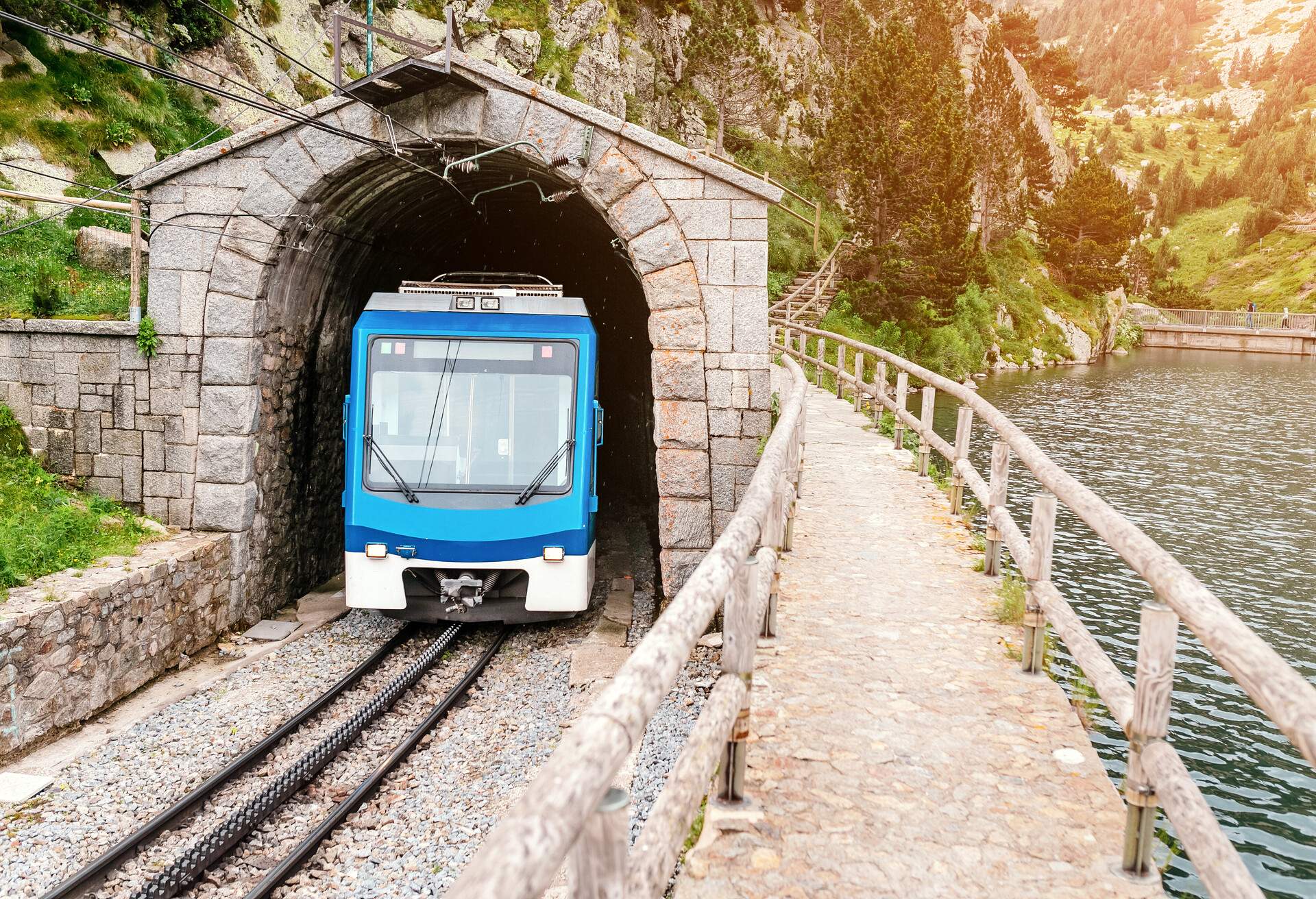 The train leaves the tunnel in the mountains