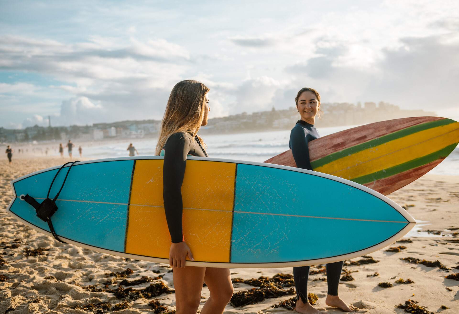 Surfing is a way of living in Australia and young and mature sporty women go surfing every morning.