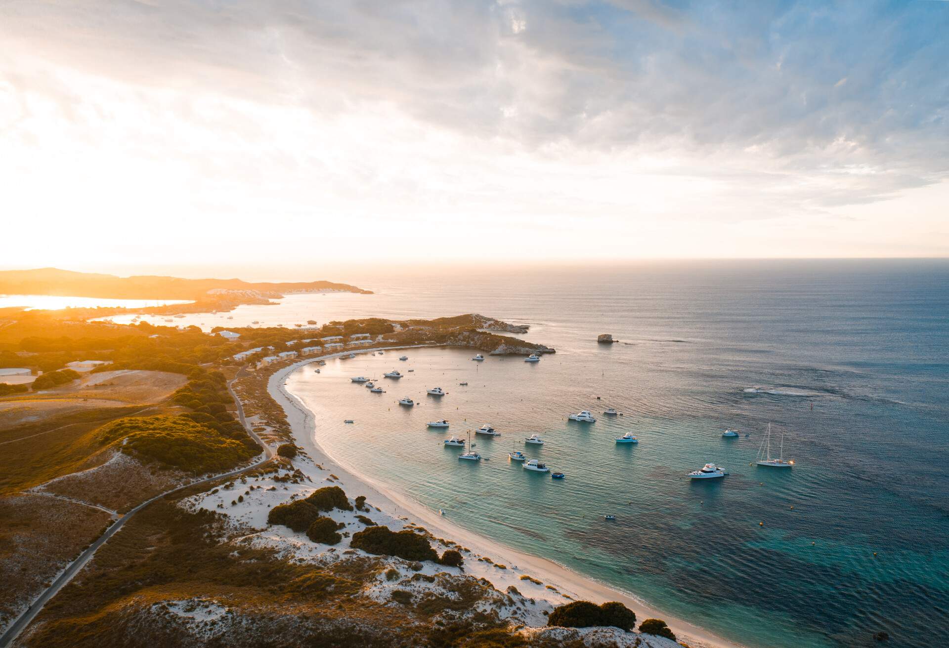 Aerial drone photo of Rottnest Island, Geordie Bay. Sunset in the background as the private boats park up for the night in the secluded and remote bay. ; Shutterstock ID 1684196053; Brand (KAYAK, Momondo, Any): KAYAK