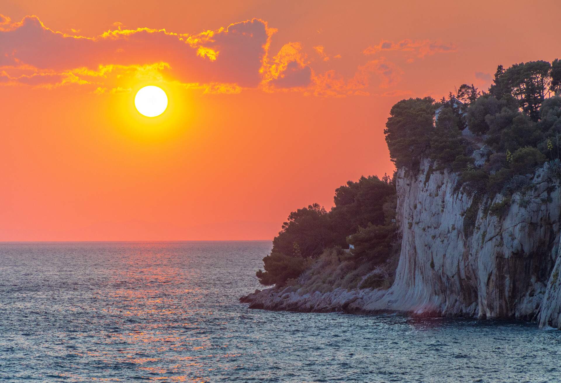 Sunset over the Adriatic sea, as seen from the Makarska Riviera, a 58km stretch of Adriatic coast at the foot of the Biokovo mountain range, in Split-Dalmatia County, southern Croatia.