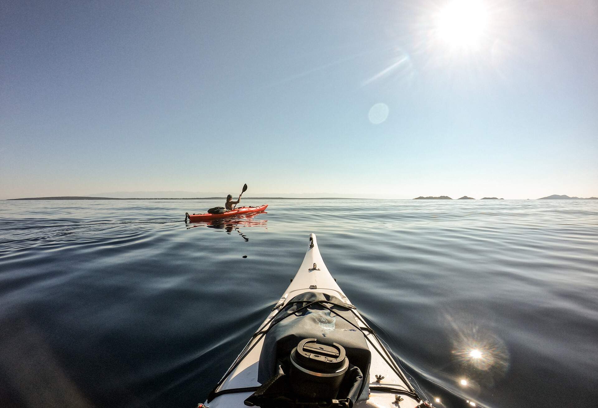 Man and woman sea kayaking point of view