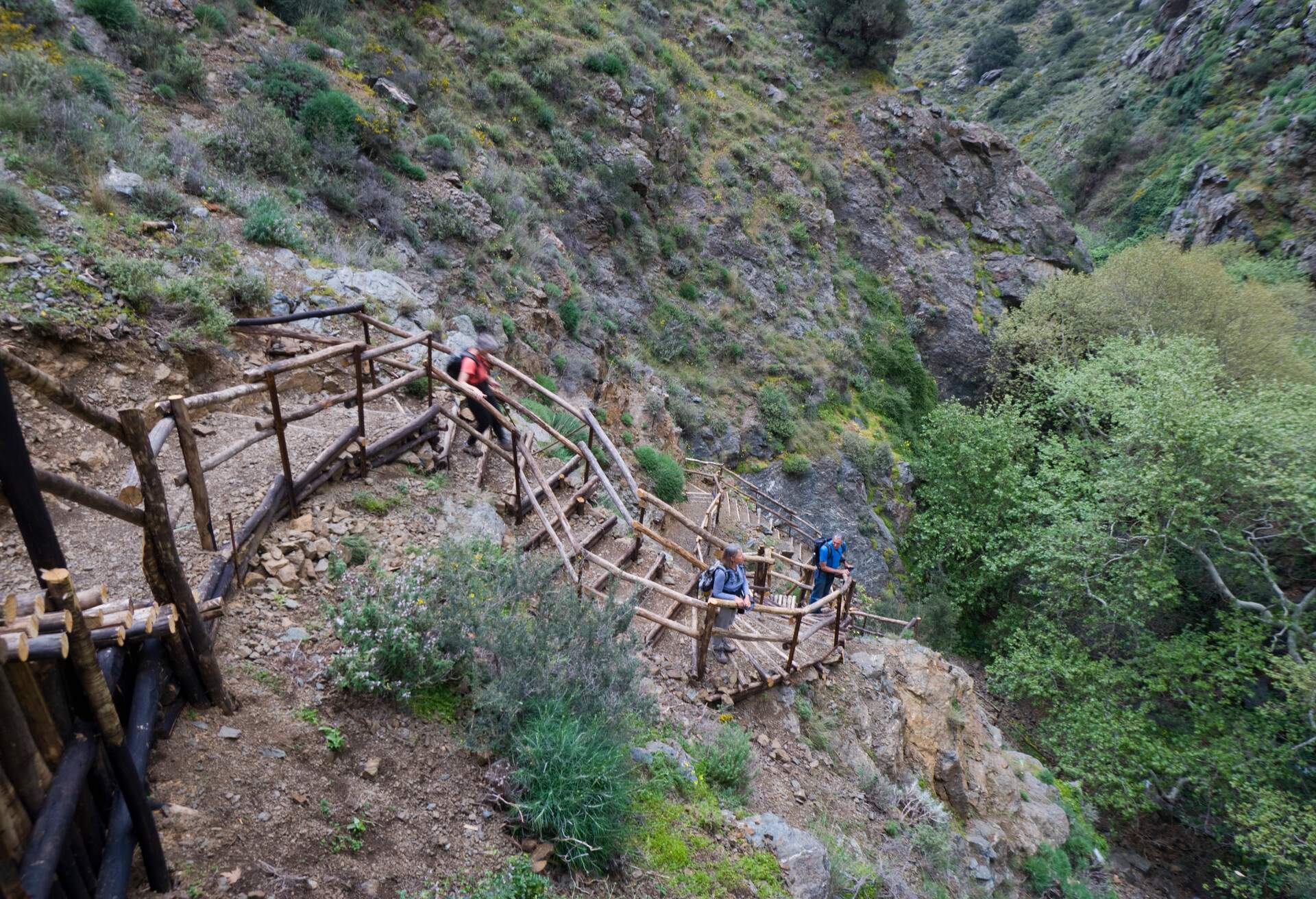 Crete. Greece. Europe. Visitors on wooden stairs constructed down steep slope in Richtis Gorge (Rihtis, Rihti, Rixti) near town of Exo Mouliana. Lasithi Region. MR