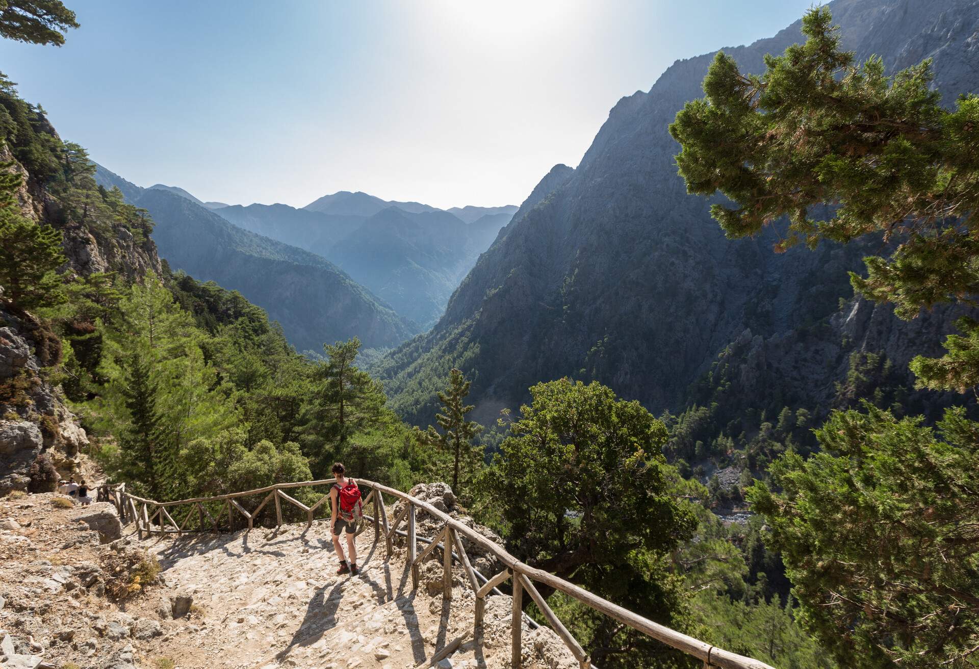 A woman on her way down to the entrance of Samaria Gorge, Crete. The gorge is in southwest Crete in the regional unit of Chania and a major tourist attraction of the island. It was created by a small river running between the White Mountains and Mt. Volakias. The gorge is 16 km long, starting at an altitude of 1,250 m (4100 ft.)at the northern entrance, and ending at the shores of the Libyan Sea in Agia Roumeli.