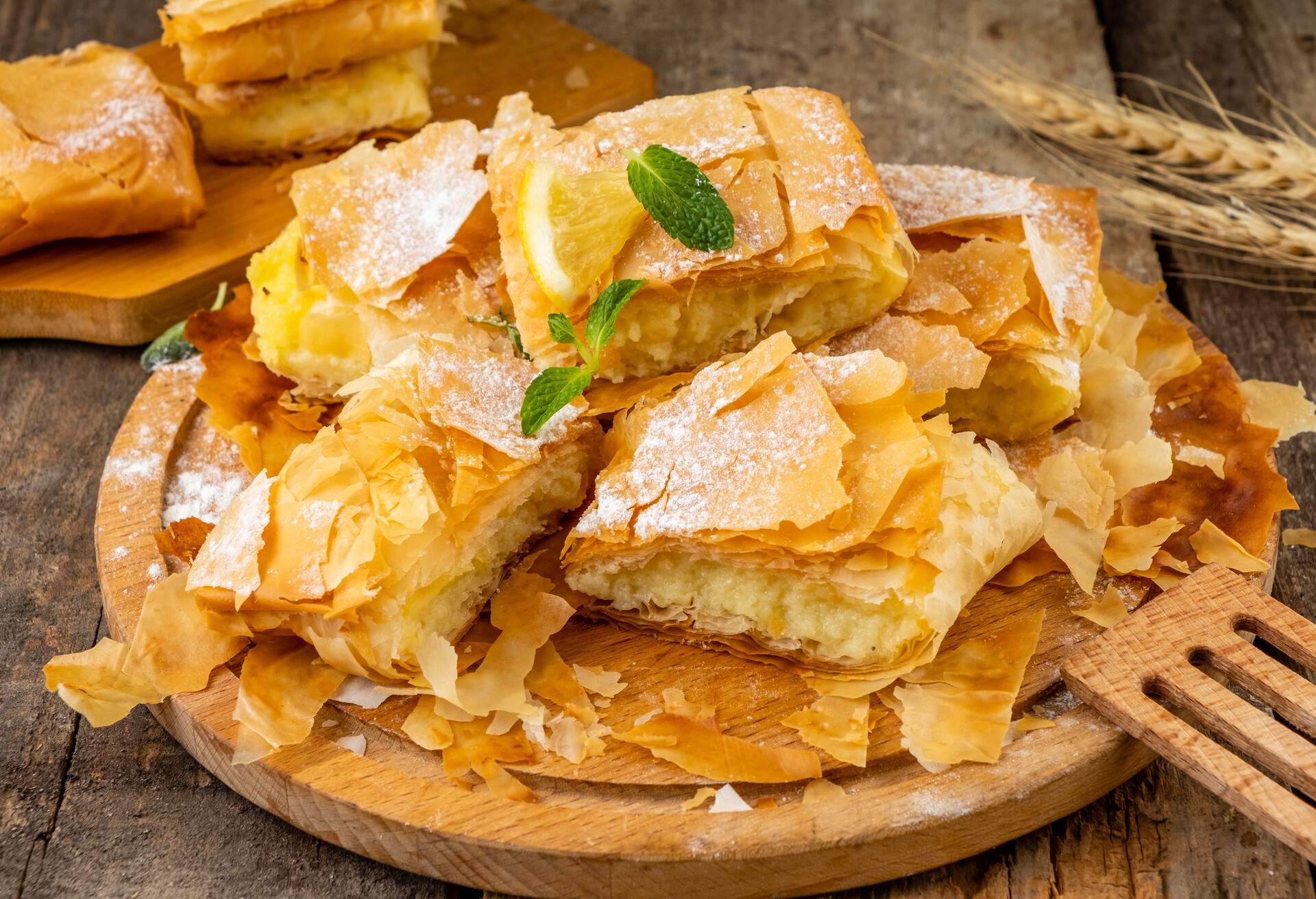 Puff pastry filo pastry stuffed with semolina custard. Wooden table. Bougatsa