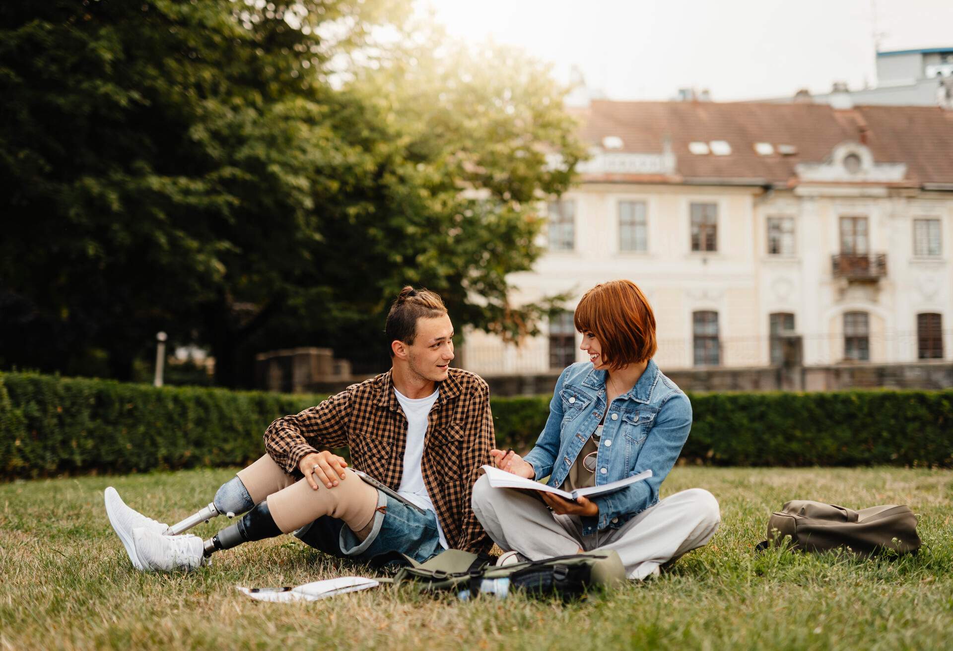 Friends students spend time together, learning outdoors in park.