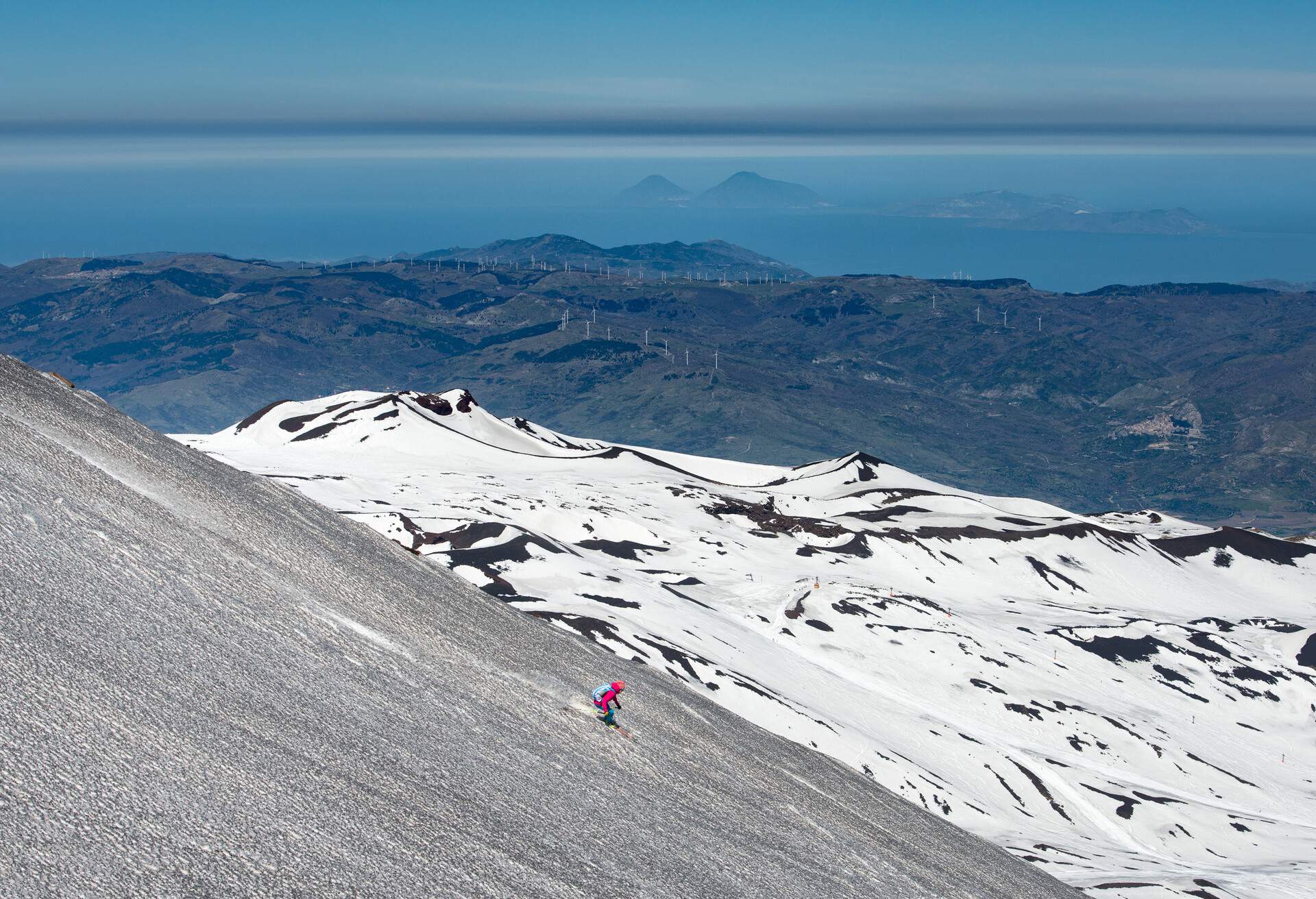 Skiing on the Etna volcano with the background of Lipari Stromboli Aeolian Islands Italy