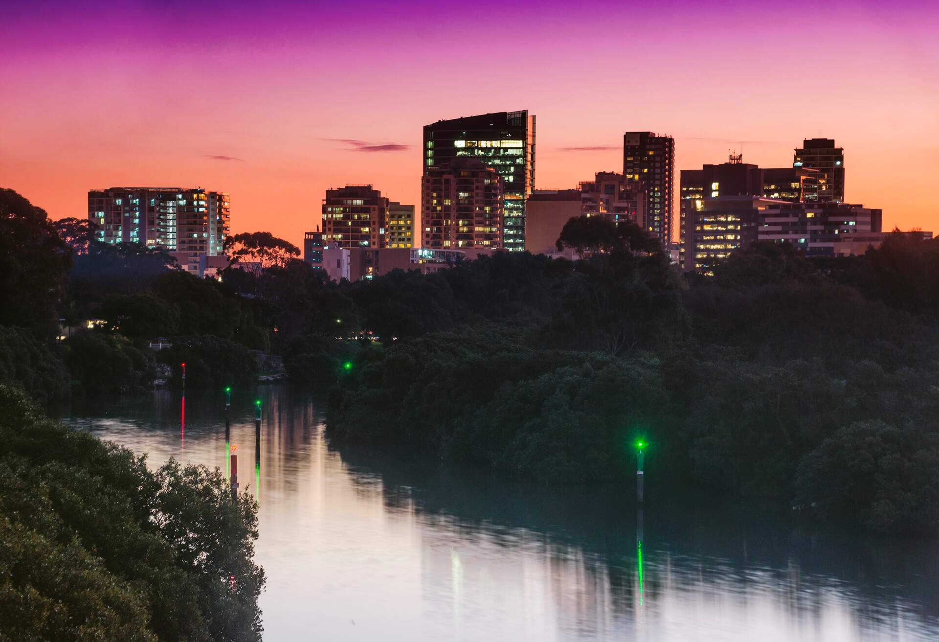 Parramatta CBD at dusk, with the Parramatta River before it.