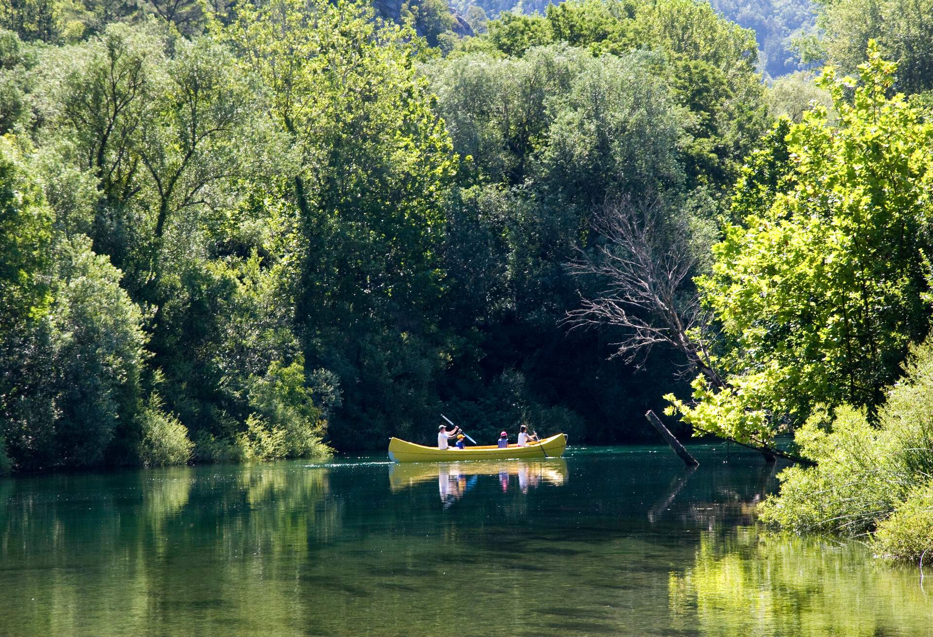 Family are rowing in canoe along the river Cetina in Croatia