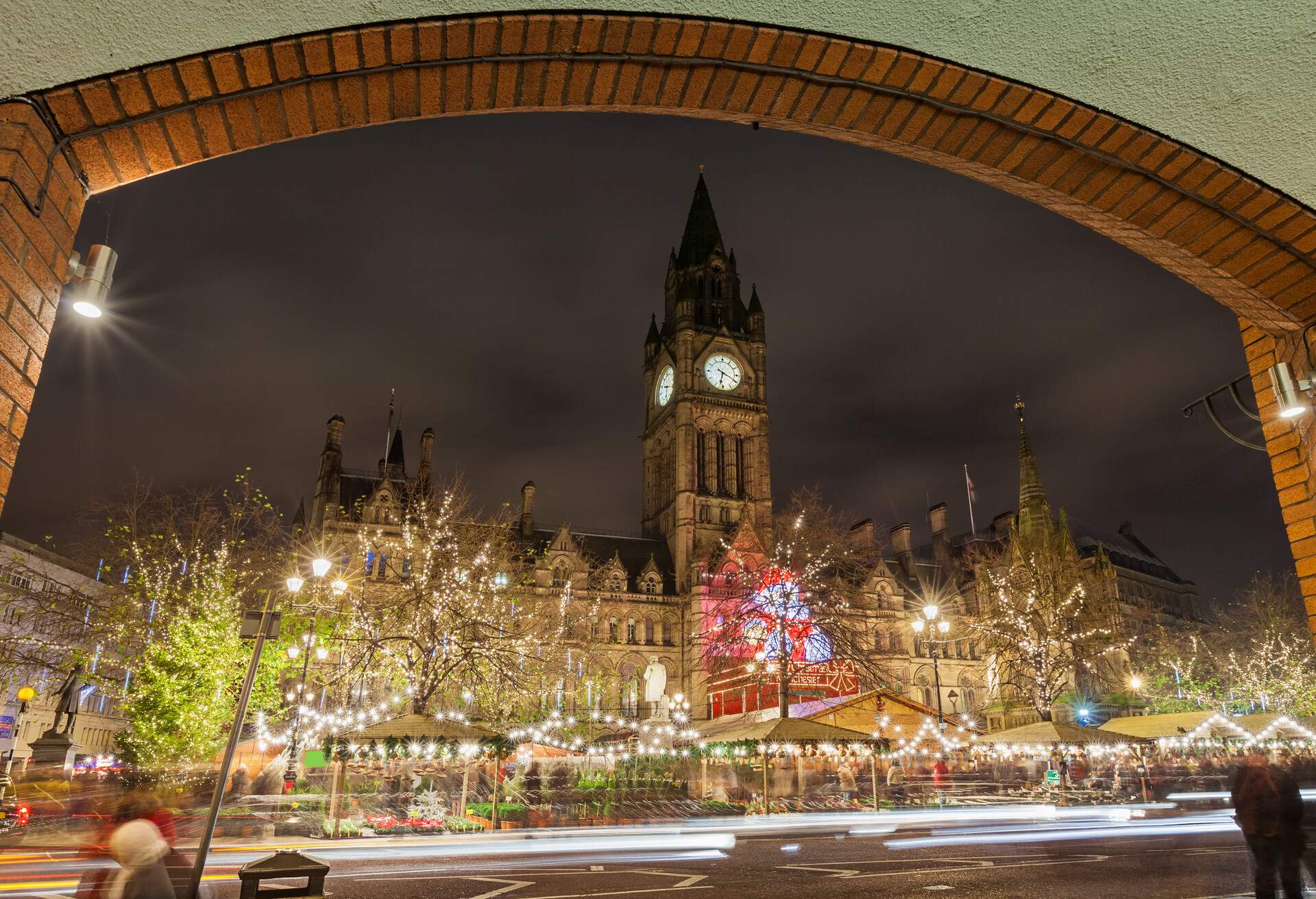 Stock photograph of the Christmas market below the City Hall in Manchester England UK at night.