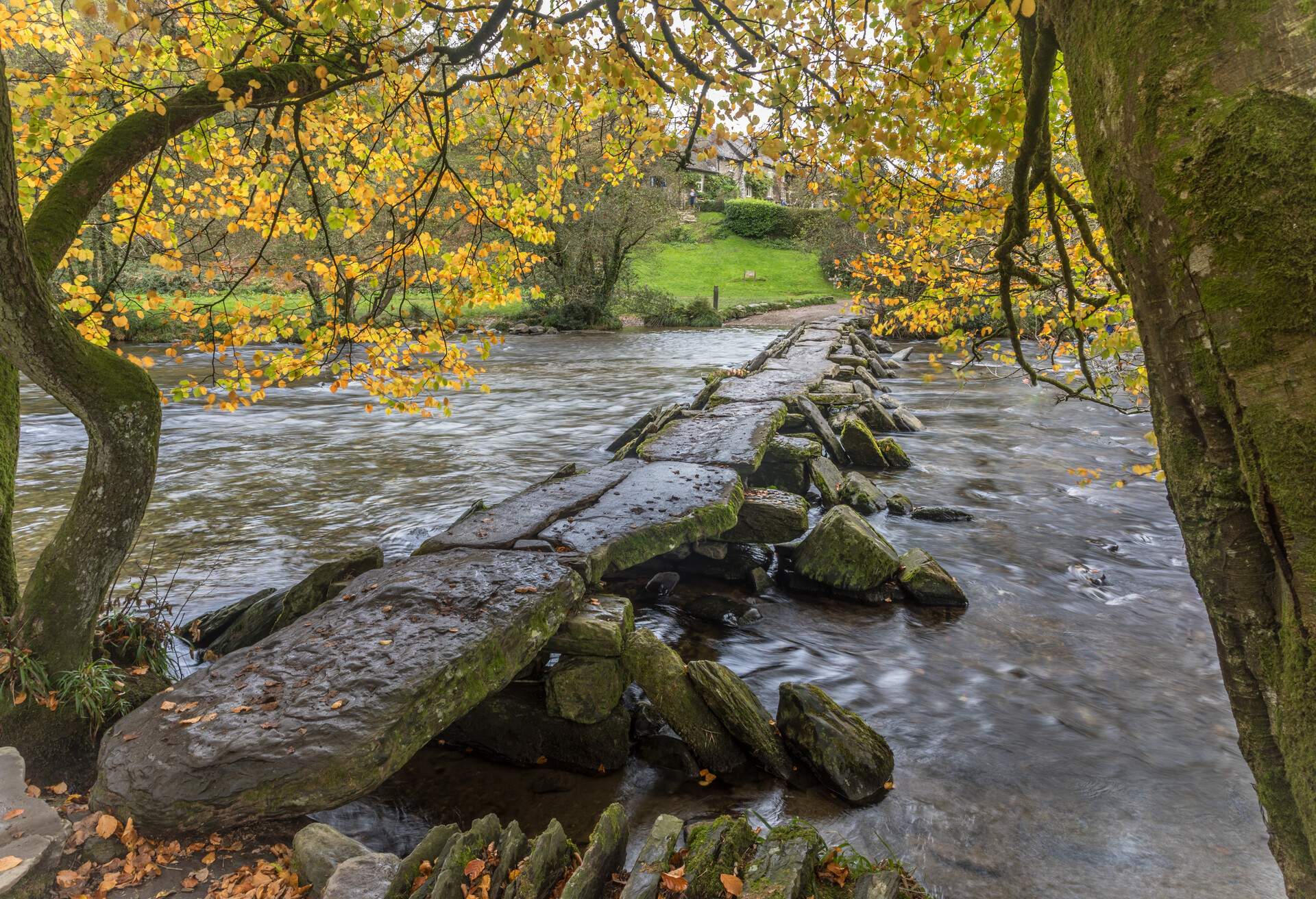 A view of Tarr Steps, a clapper bridge across the river Barle in the Exmoor National Park, Somerset, England.