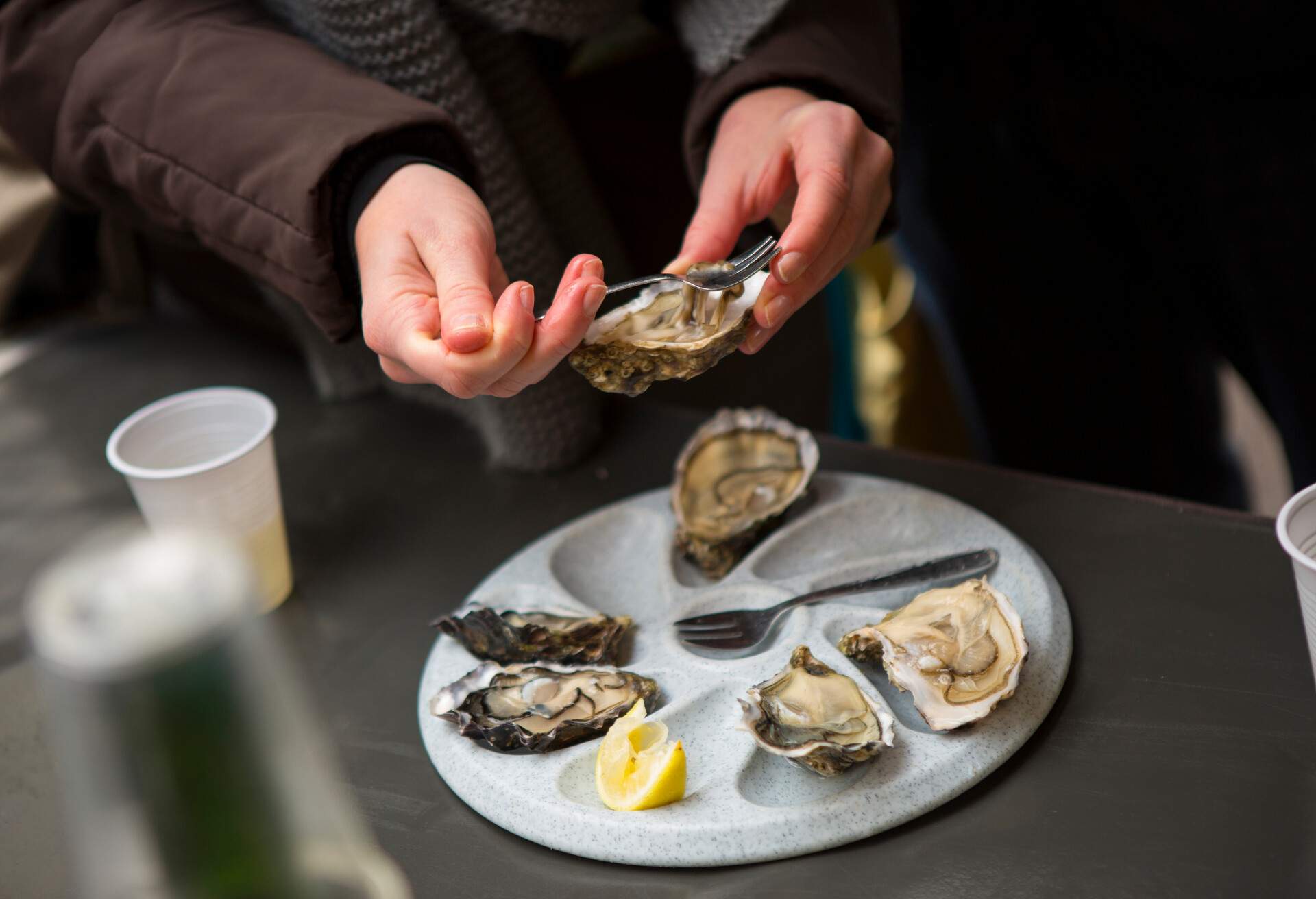 eating oysters on the half-shell at Sunday open air produce market at La Bastille, Paris