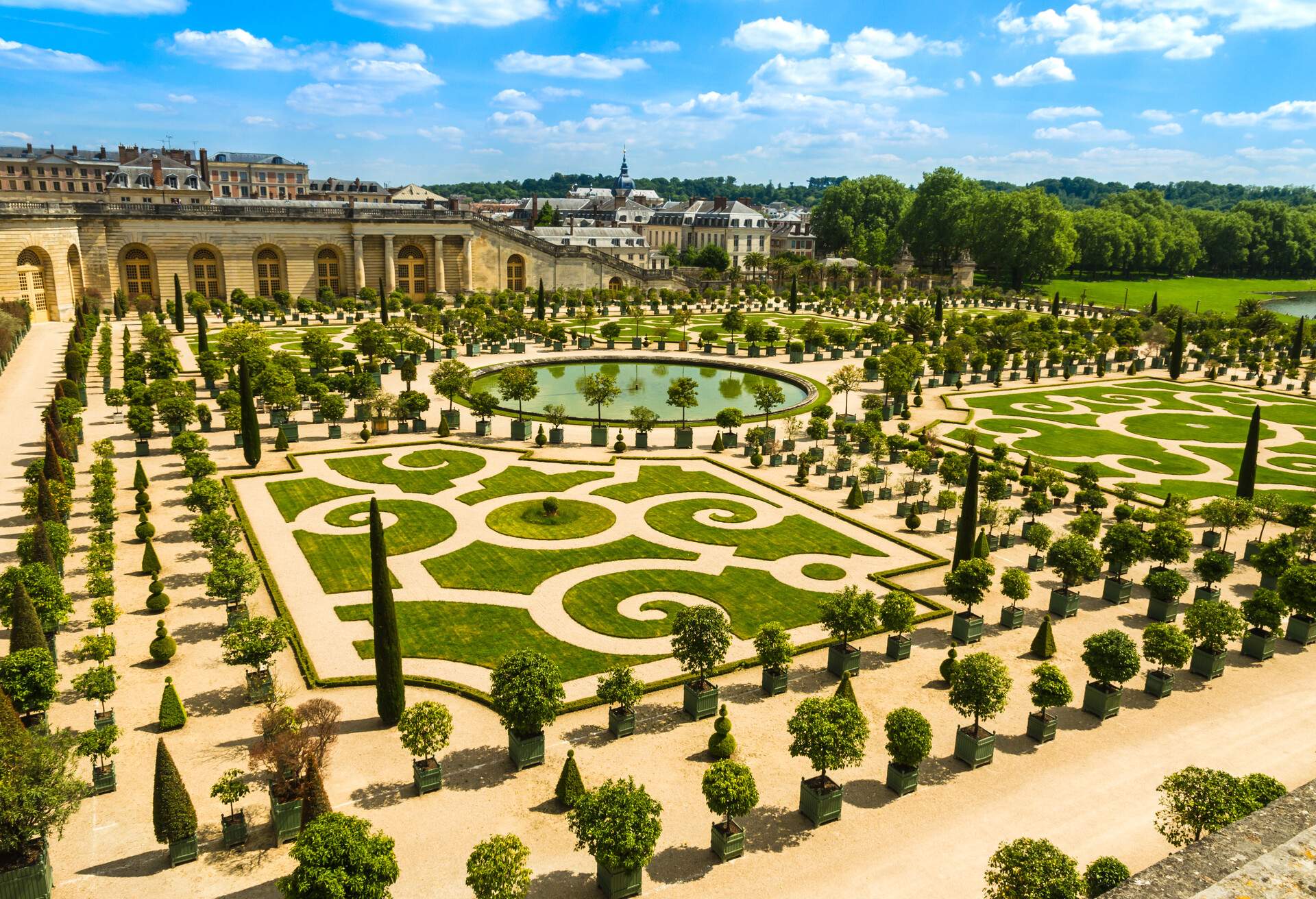 A birds eye perspective of the beautiful and perfectly cut garden with trees and bushes in Versailles, France