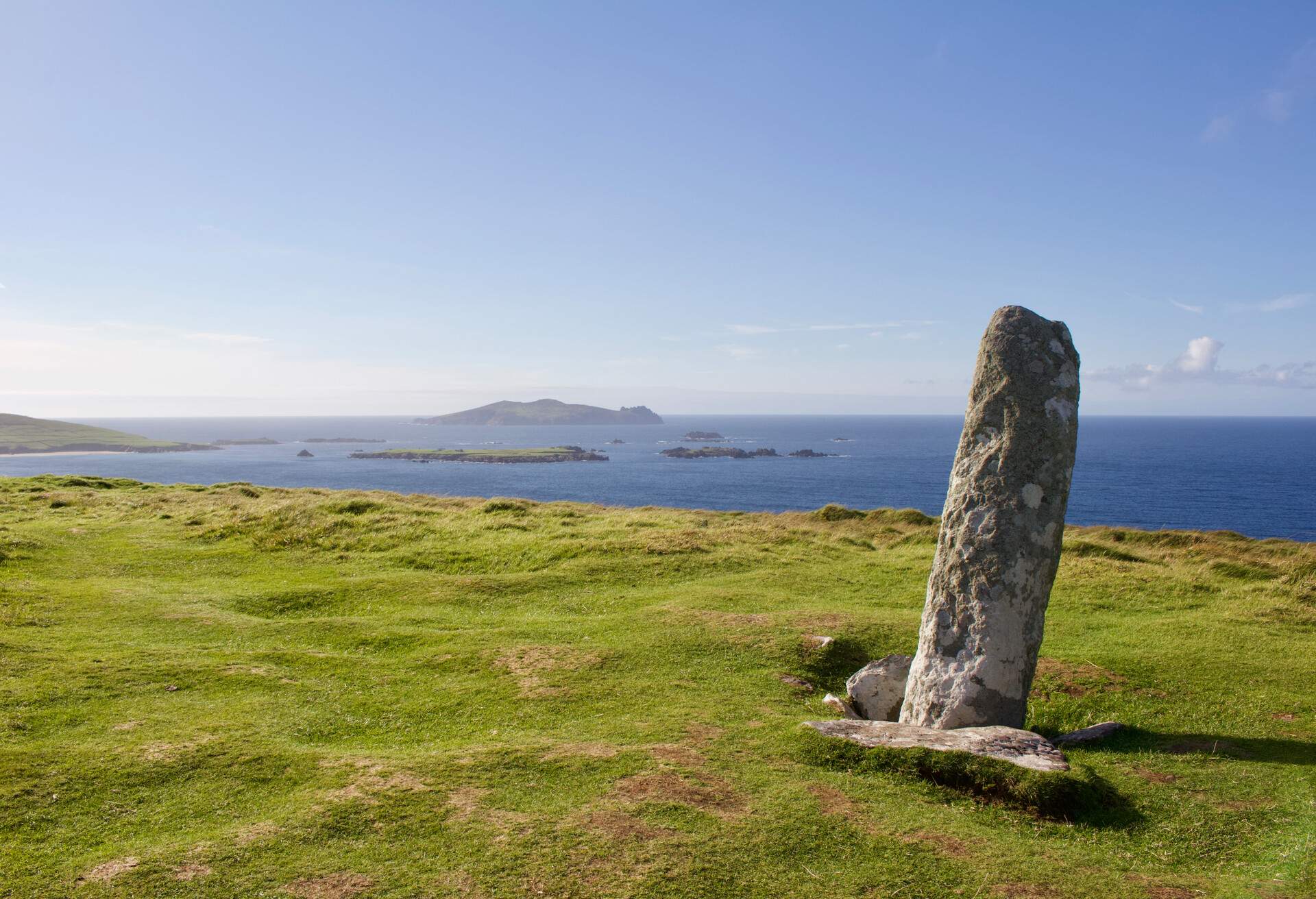This image features an ancient ogham stone obelisk atop Dunmore Head on the Dingle Peninsula in County Kerry, Ireland.